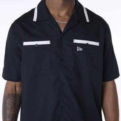 The Male model is wearing New Era Revere Black Short Sleeve Shirt 3