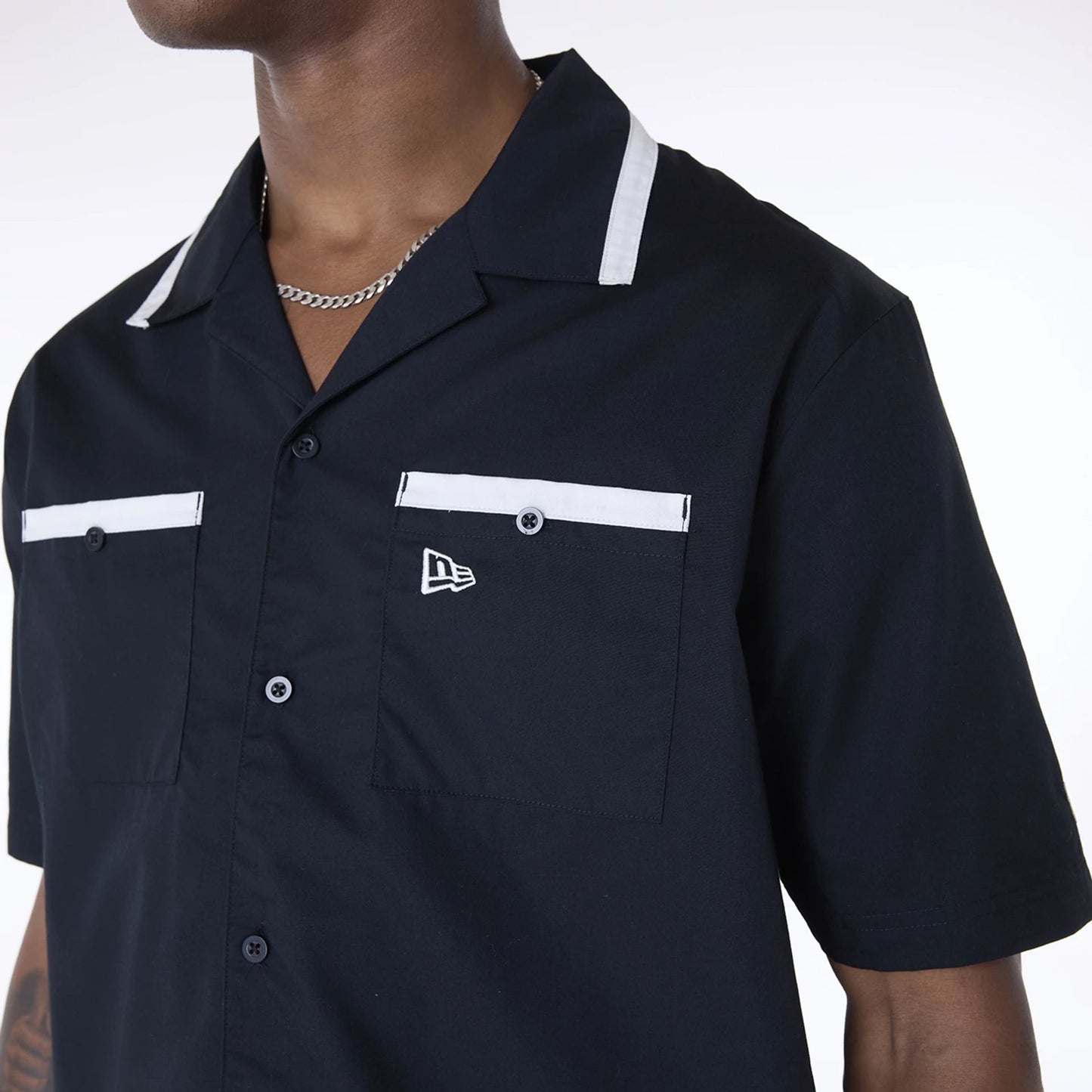 The Male model is wearing New Era Revere Black Short Sleeve Shirt 4