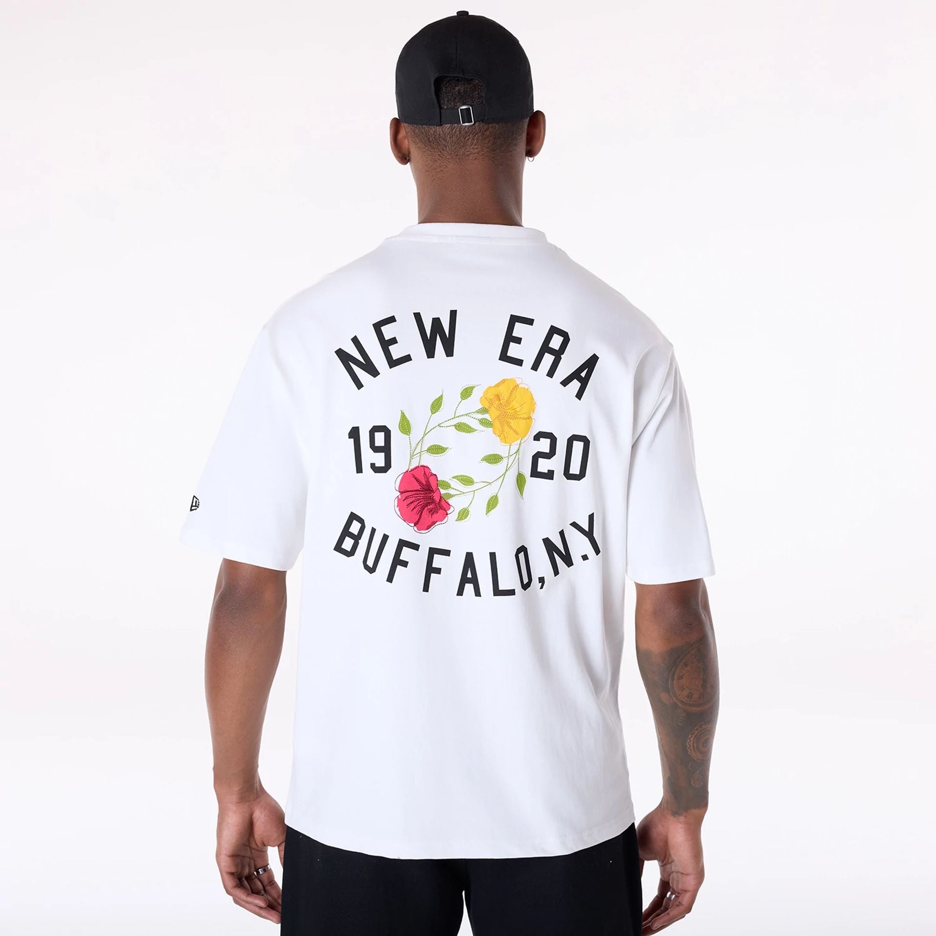 The Male model is wearing New Era Floral Graphic White T-Shirt 2