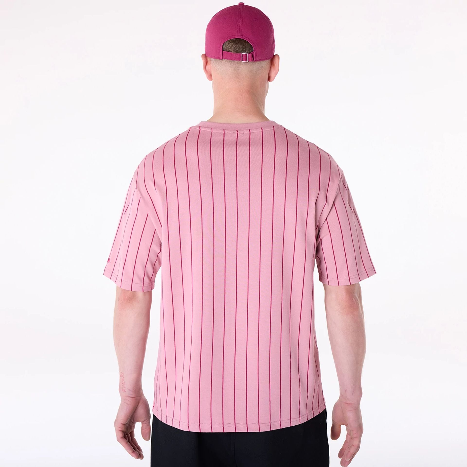 The Male model is wearing New Era Pinstripe Dark Pink Oversized T-Shirt 2