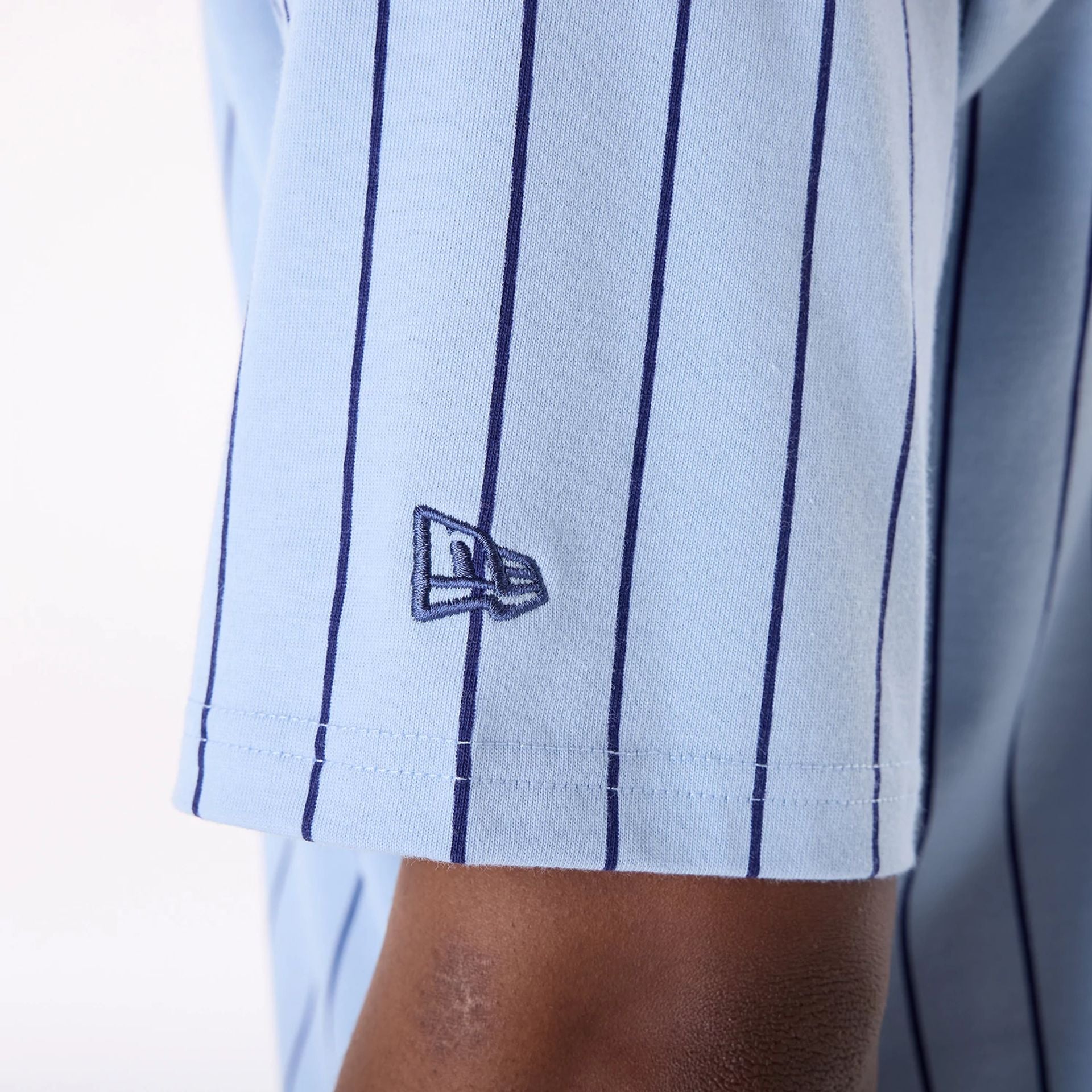 The Male model is wearing New Era Pinstripe Pastel Blue Oversized T-Shirt 6