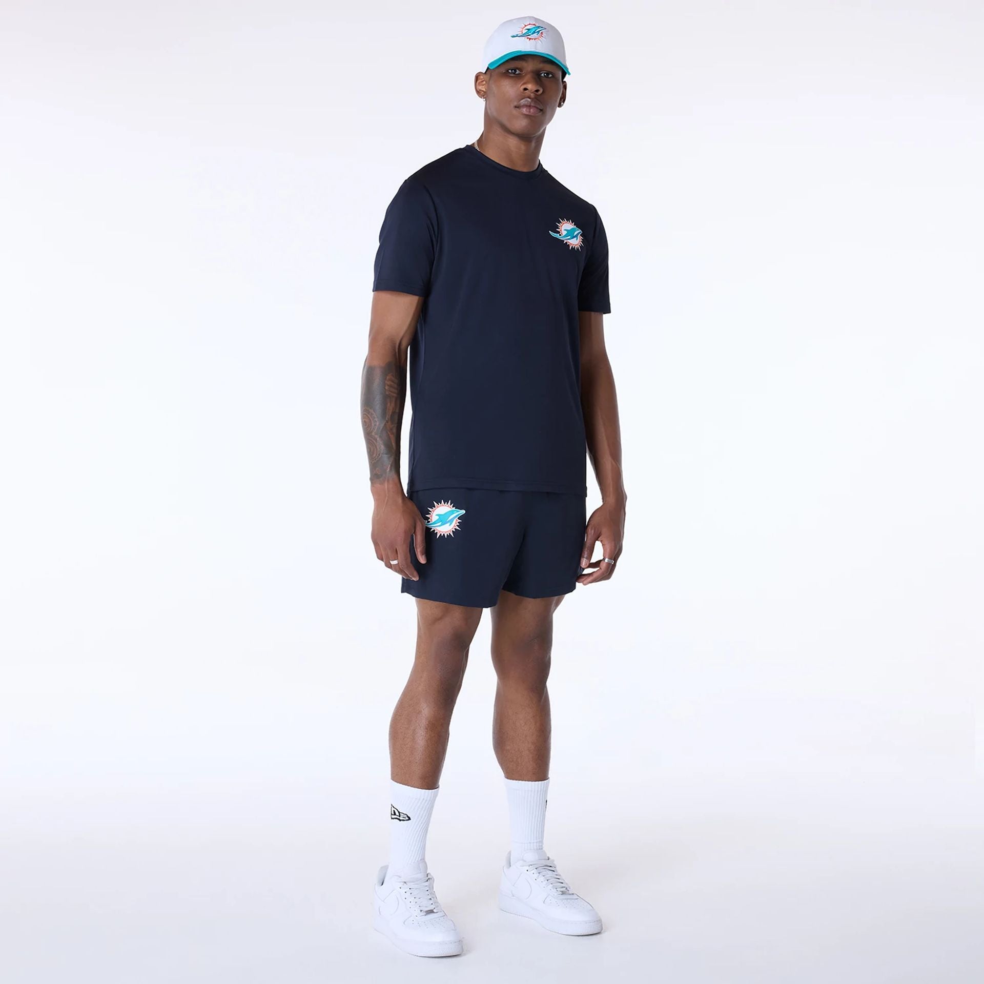 The Male model is wearing Miami Dolphins NFL Essentials Navy Shorts 6