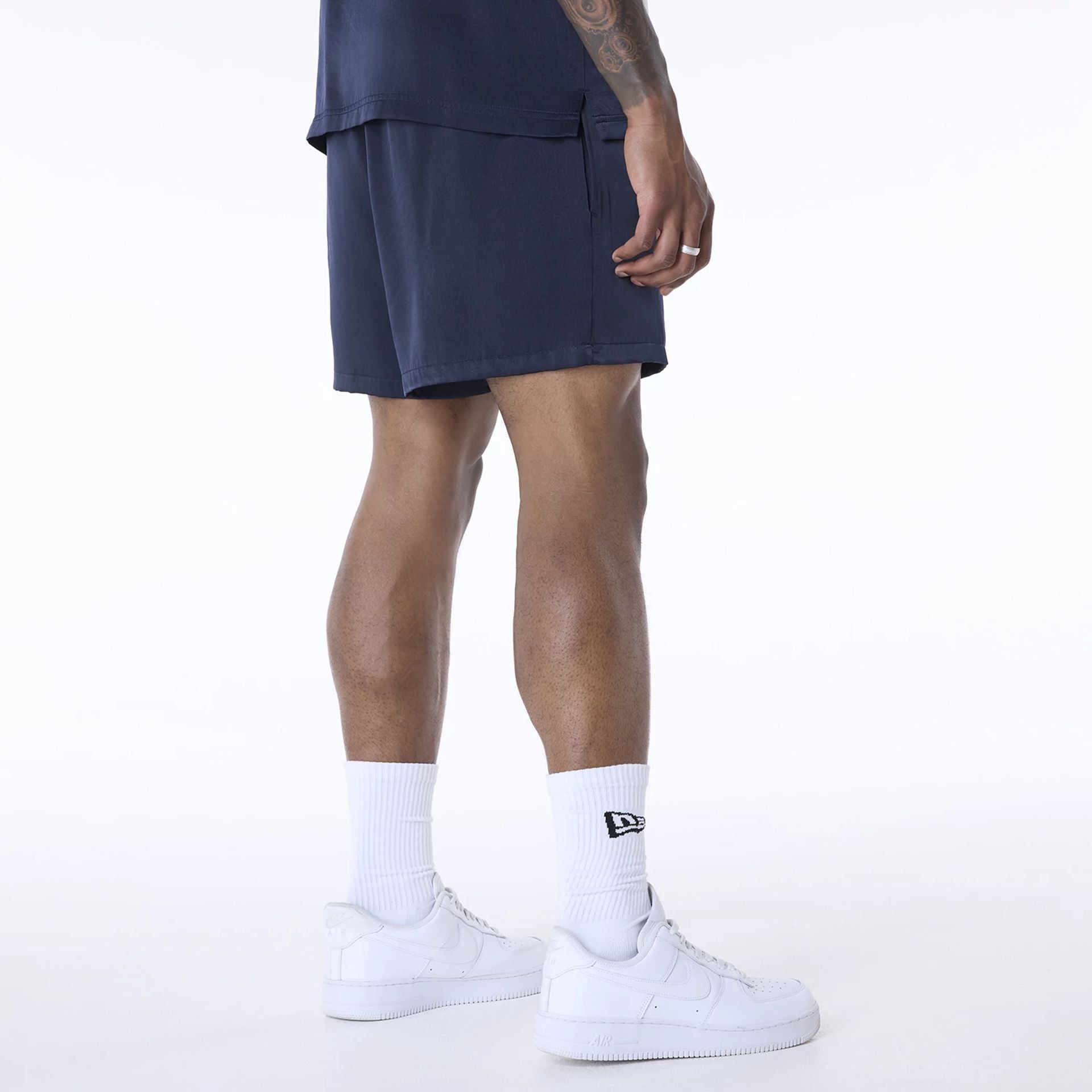 The Male model is wearing New Era Woven Navy Shorts 8