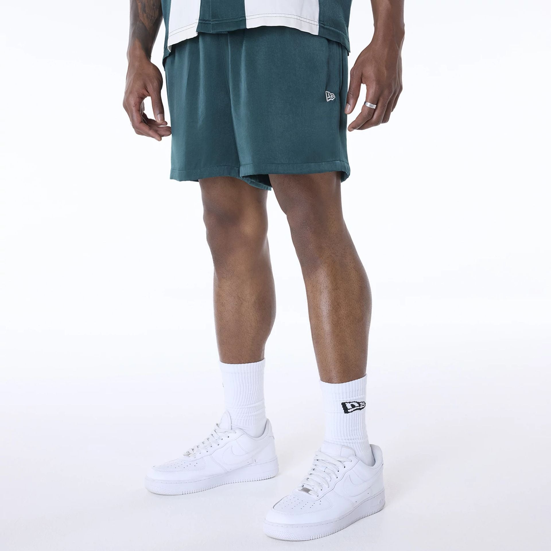 The Male model is wearing New Era Woven Dark Green Shorts 1