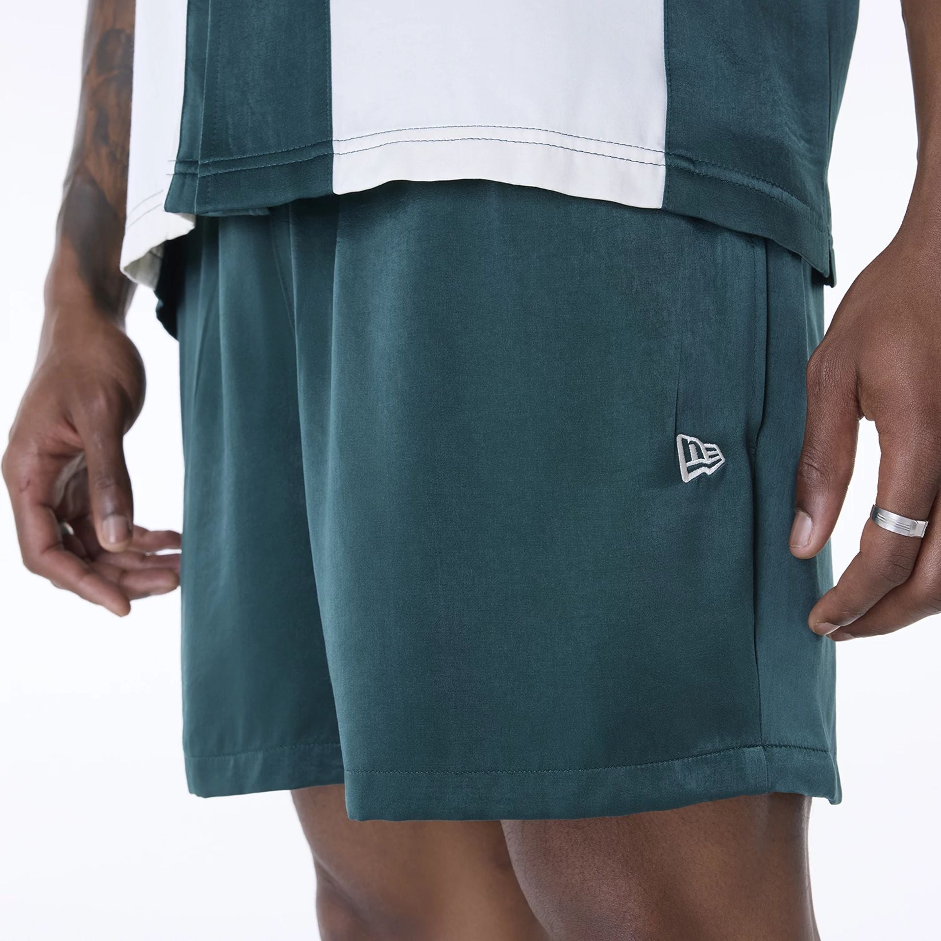 The Male model is wearing New Era Woven Dark Green Shorts 8