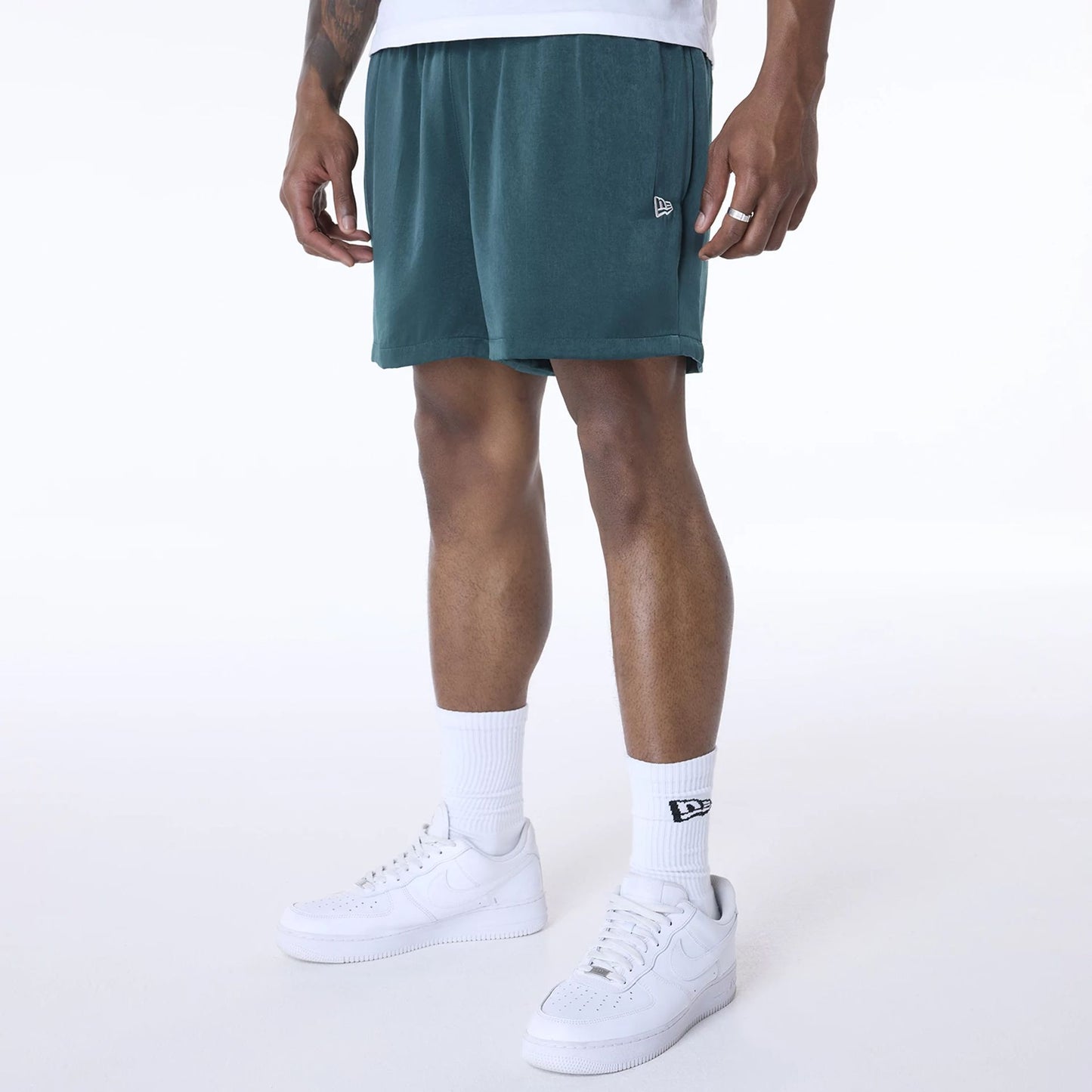 The Male model is wearing New Era Woven Dark Green Shorts 5