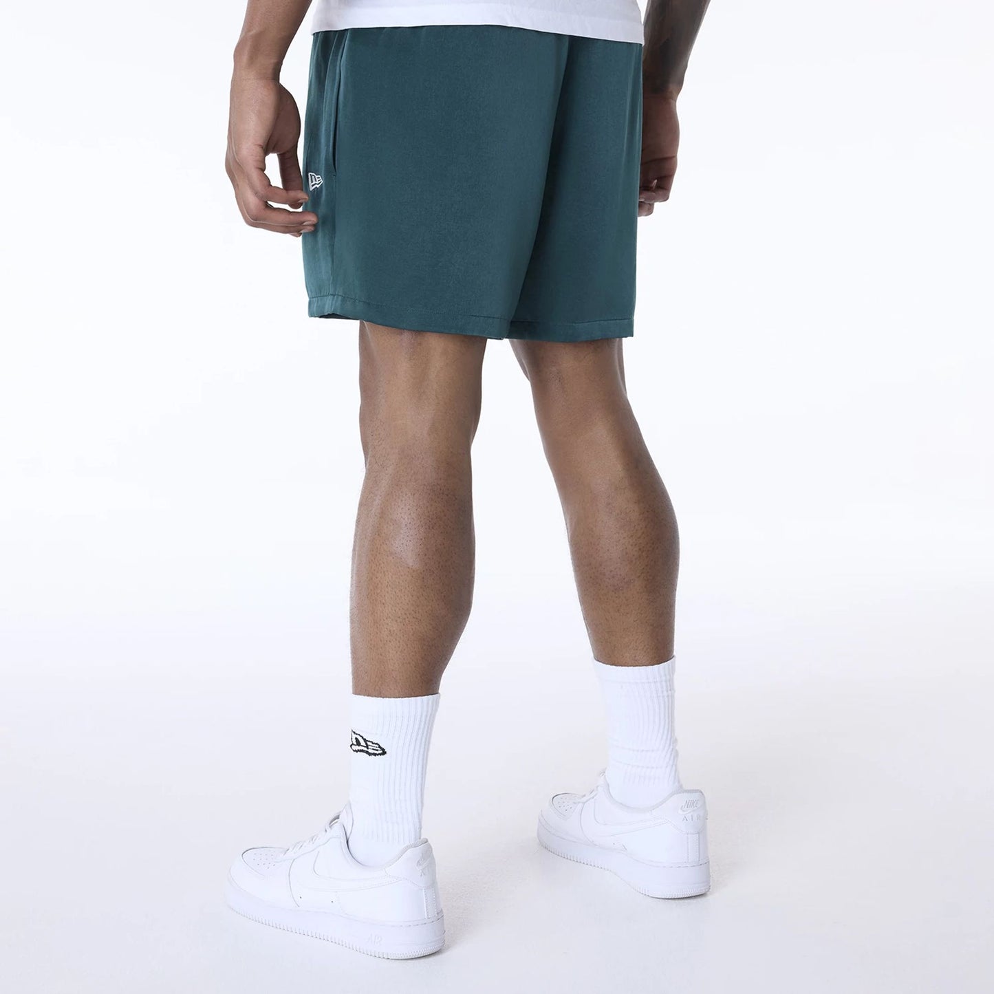 The Male model is wearing New Era Woven Dark Green Shorts 3