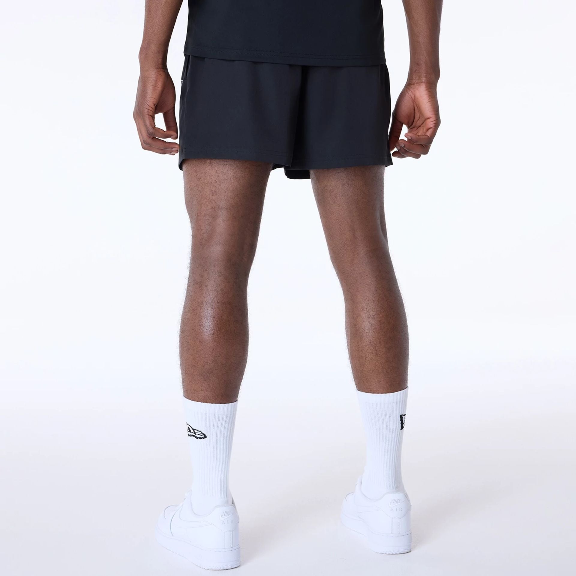 The Male model is wearing Las Vegas Raiders NFL Essentials Black Shorts 2