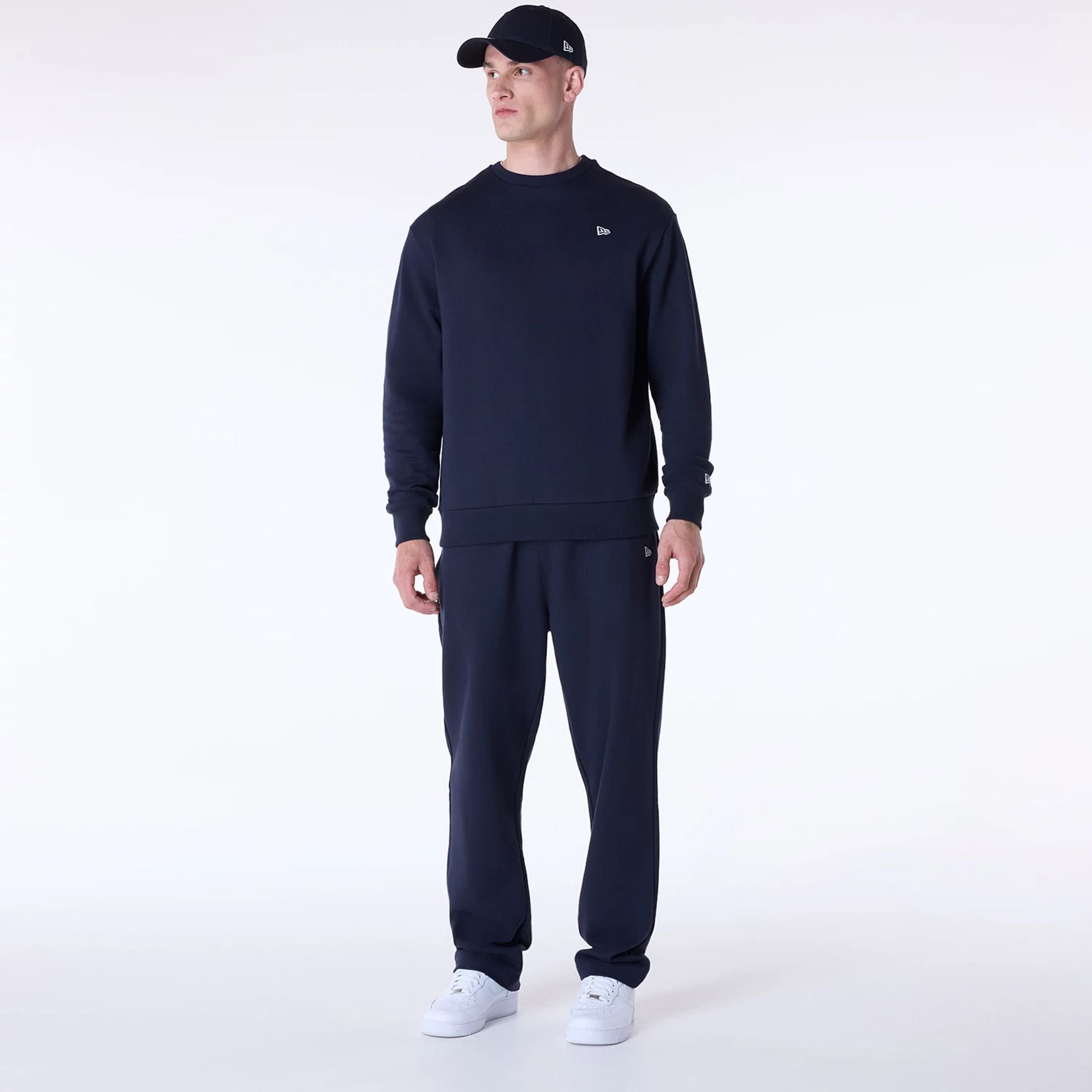 The Male model is wearing New Era Essential Navy Crew Neck Sweater 3