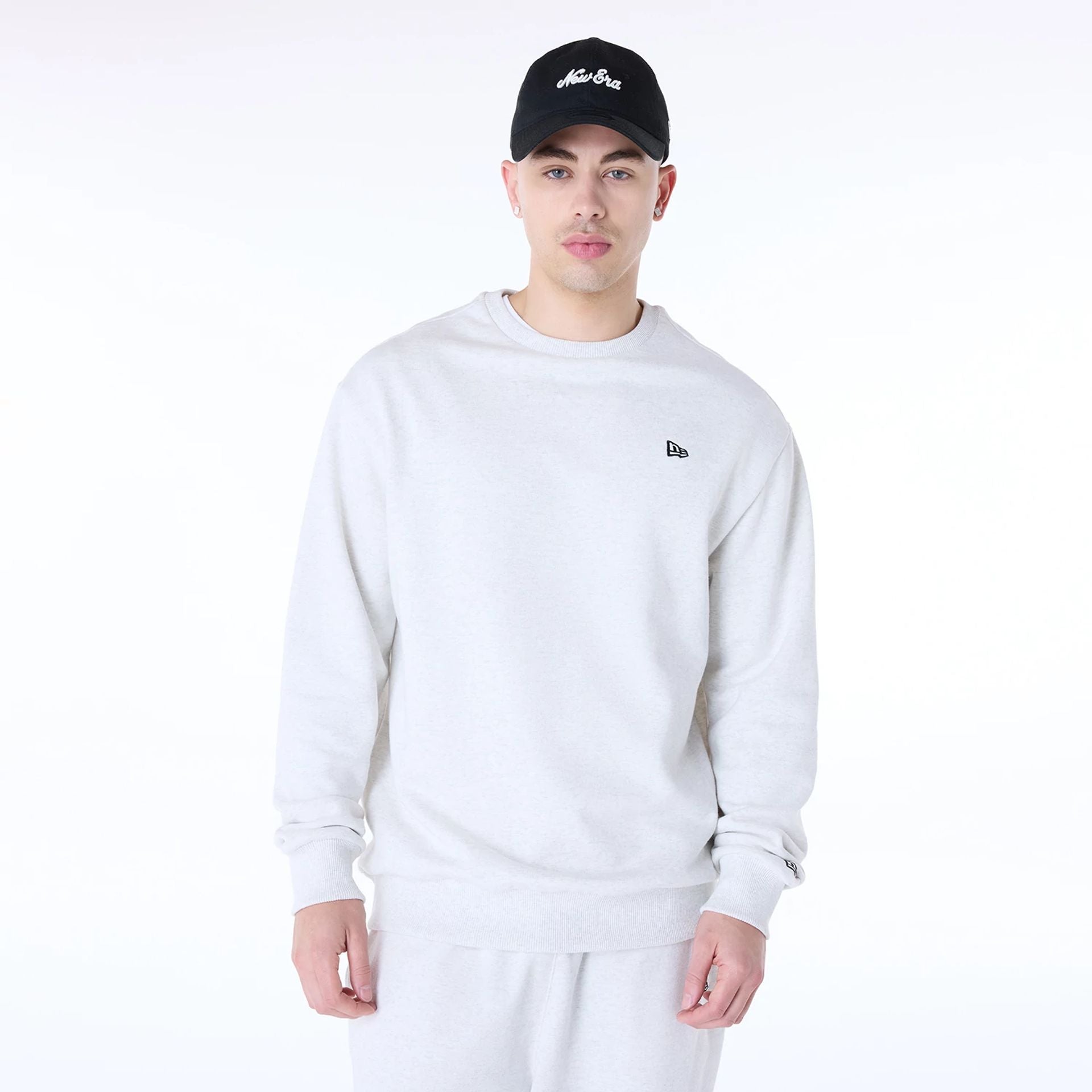 The Male model is wearing New Era Essential Pastel Grey Crew Neck Sweater 8