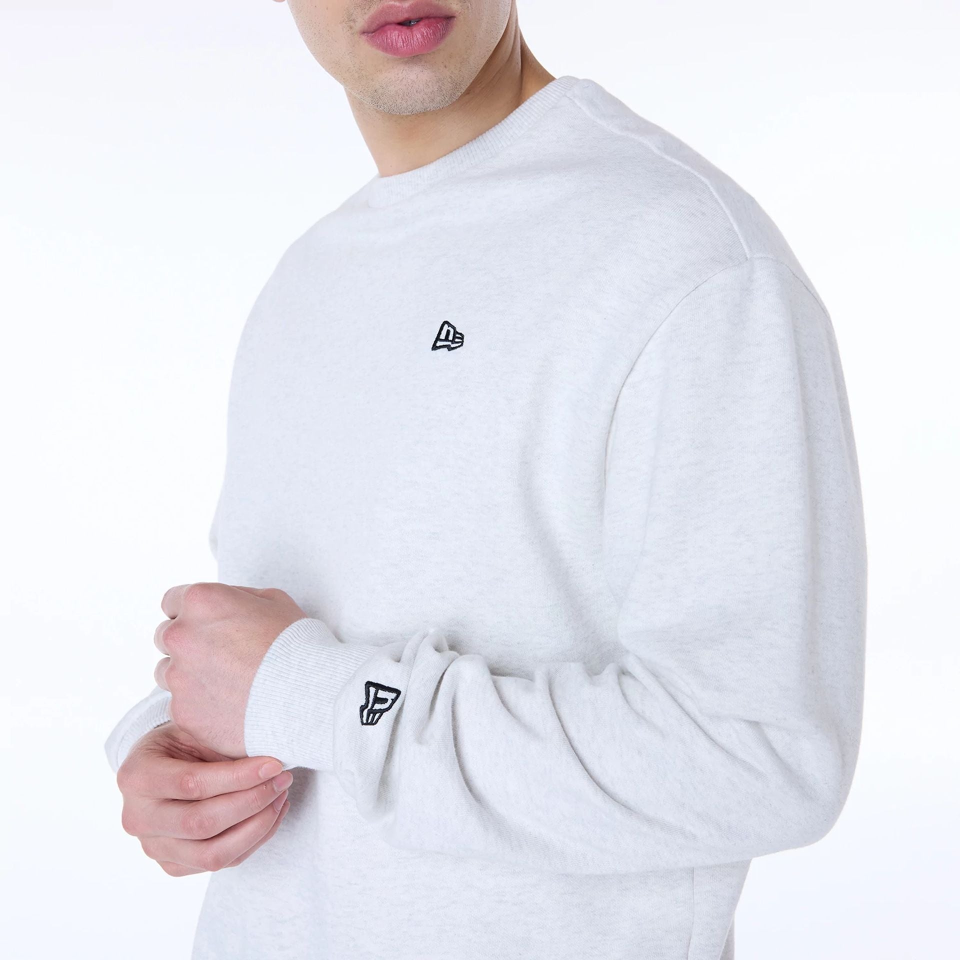 The Male model is wearing New Era Essential Pastel Grey Crew Neck Sweater 6