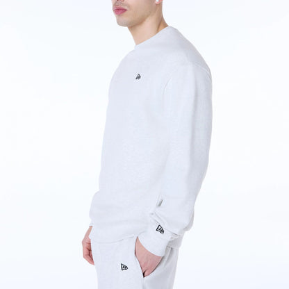 The Male model is wearing New Era Essential Pastel Grey Crew Neck Sweater 3