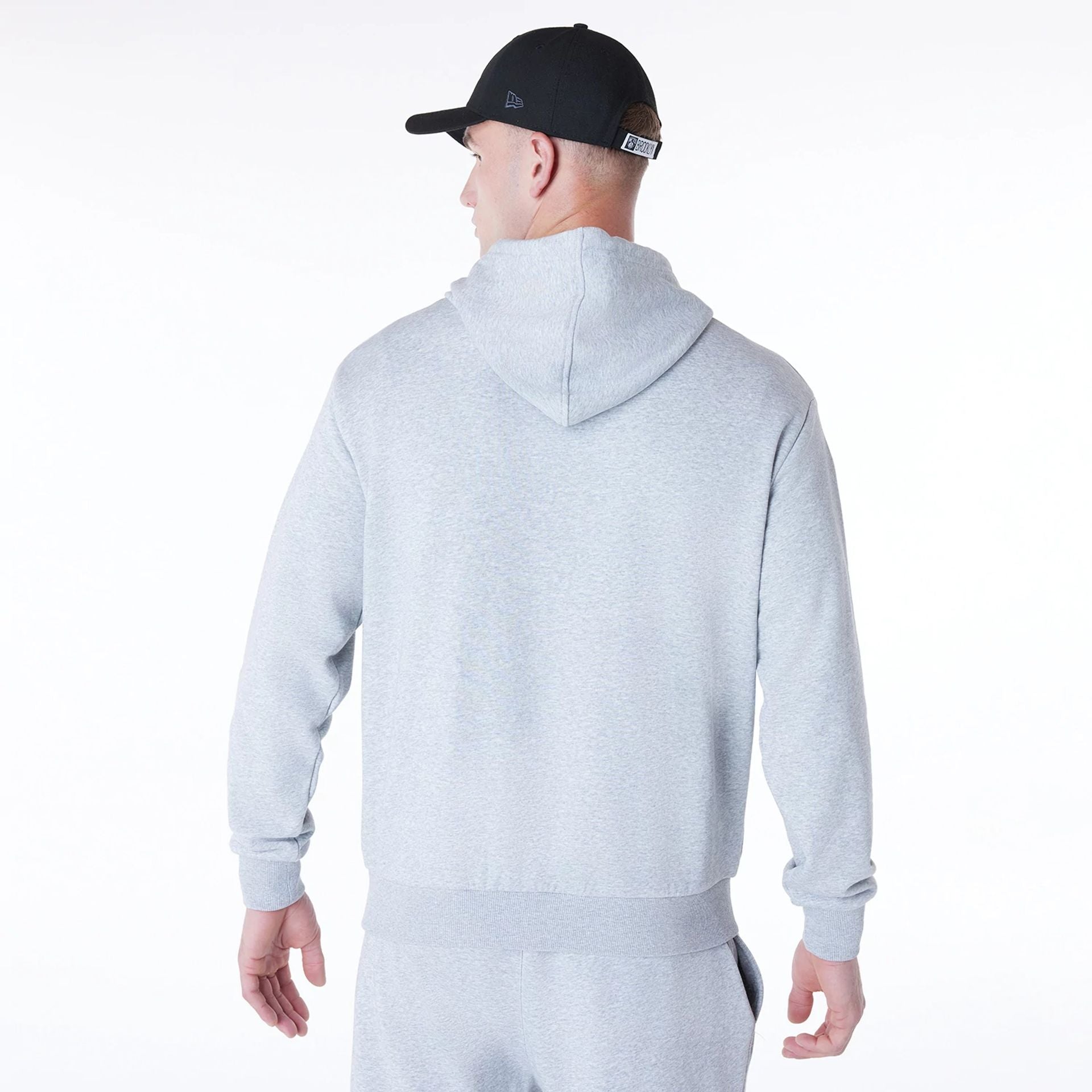 The Male model is wearing Brooklyn Nets NBA League Essential Grey Oversized Pullover Hoodie 2