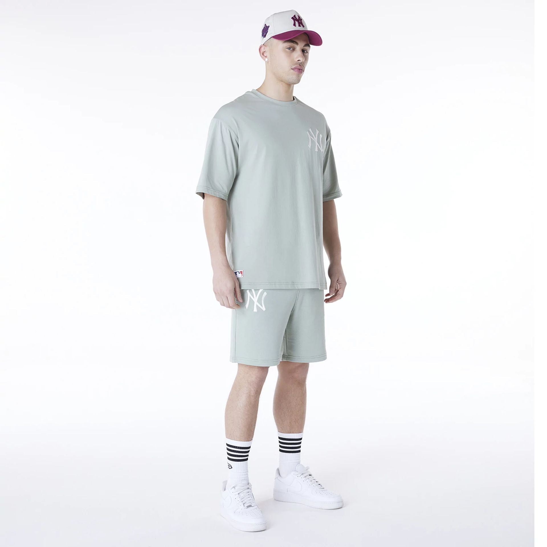 The Male model is wearing New York Yankees MLB League Essential Pastel Green Top And Shorts Set 1