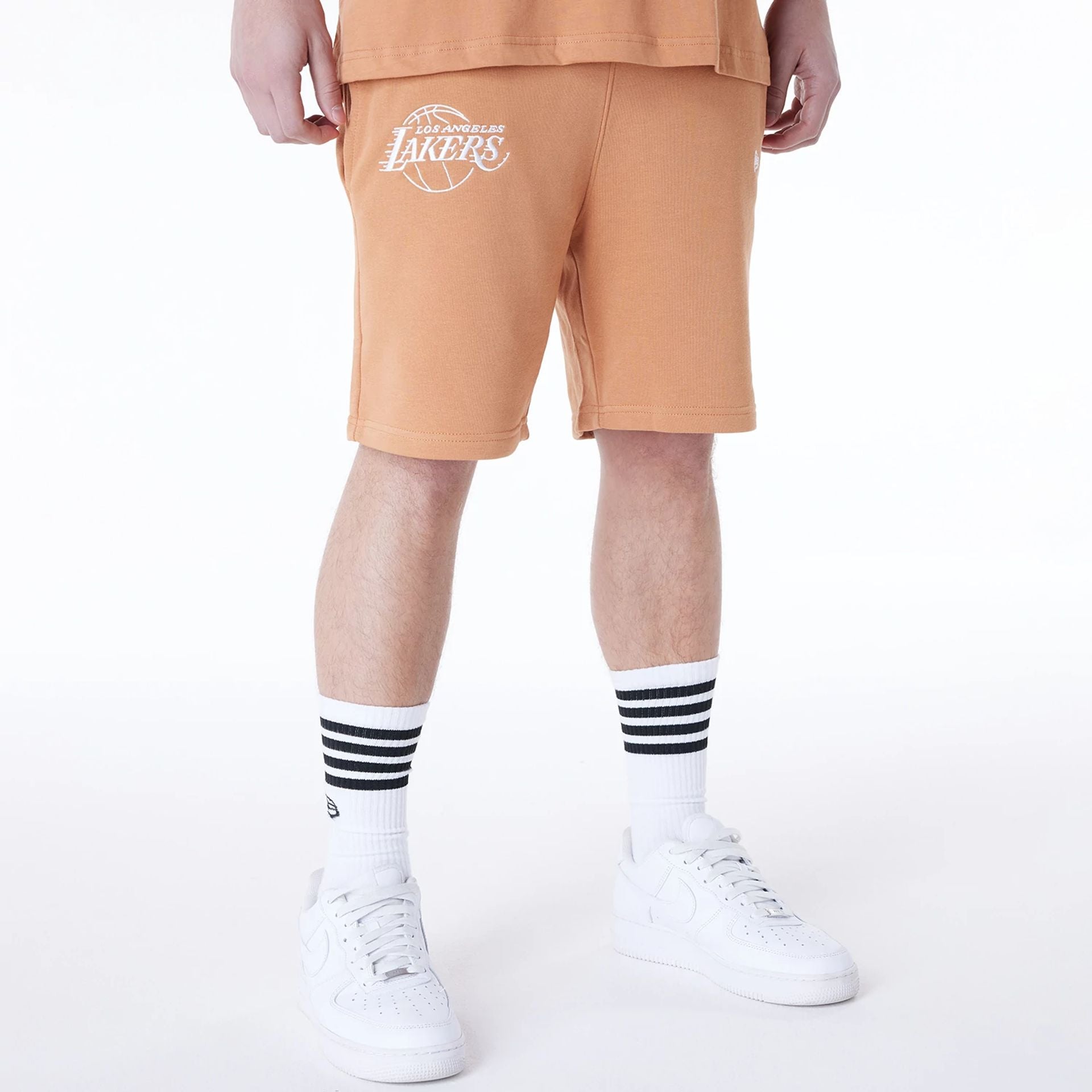 The Male model is wearing LA Lakers NBA League Essential Dark Beige Shorts 1