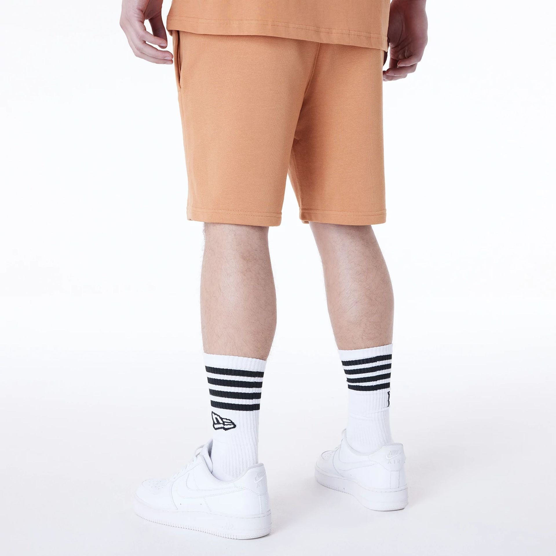 The Male model is wearing LA Lakers NBA League Essential Dark Beige Shorts 2