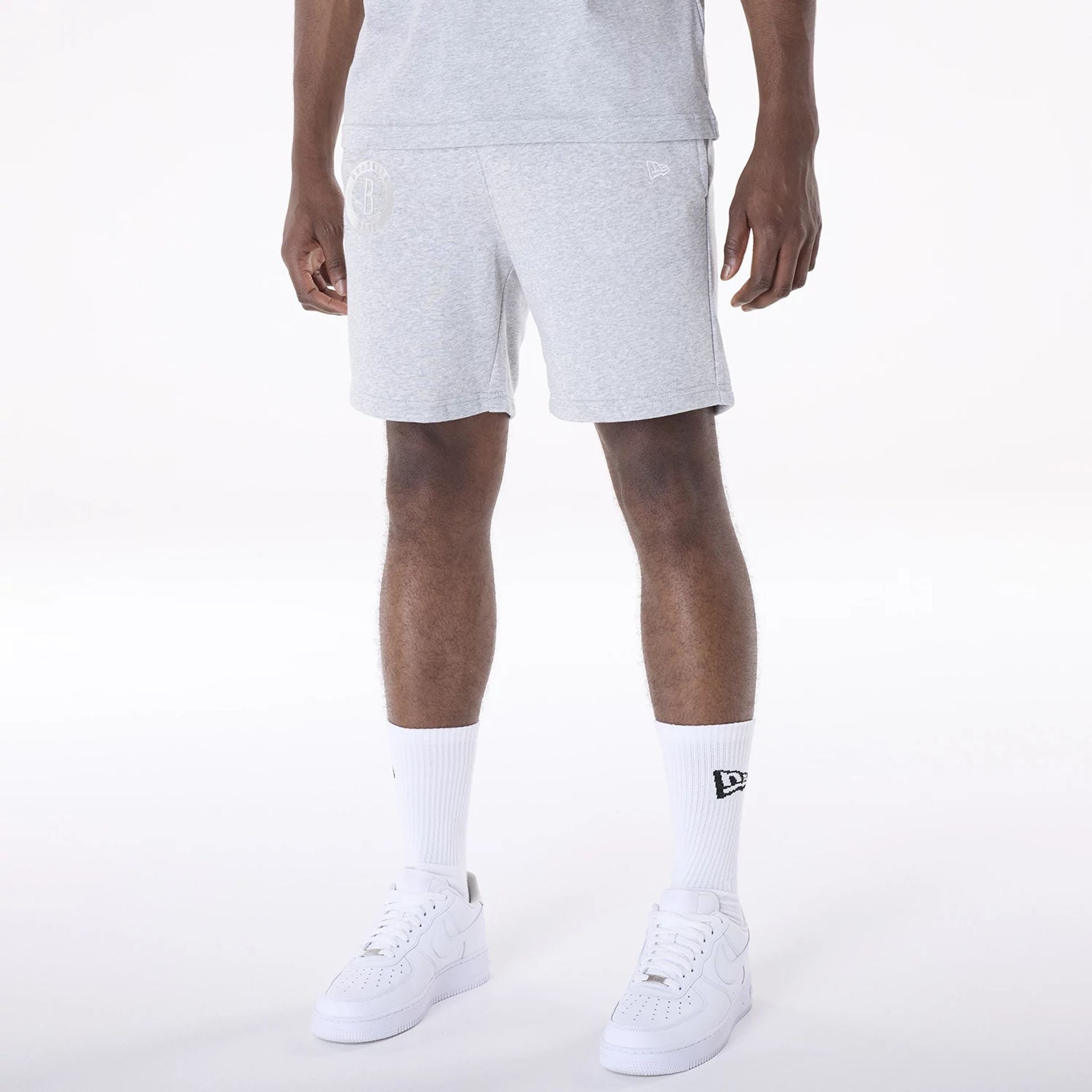 The Male model is wearing Brooklyn Nets NBA League Essential Grey Shorts 2