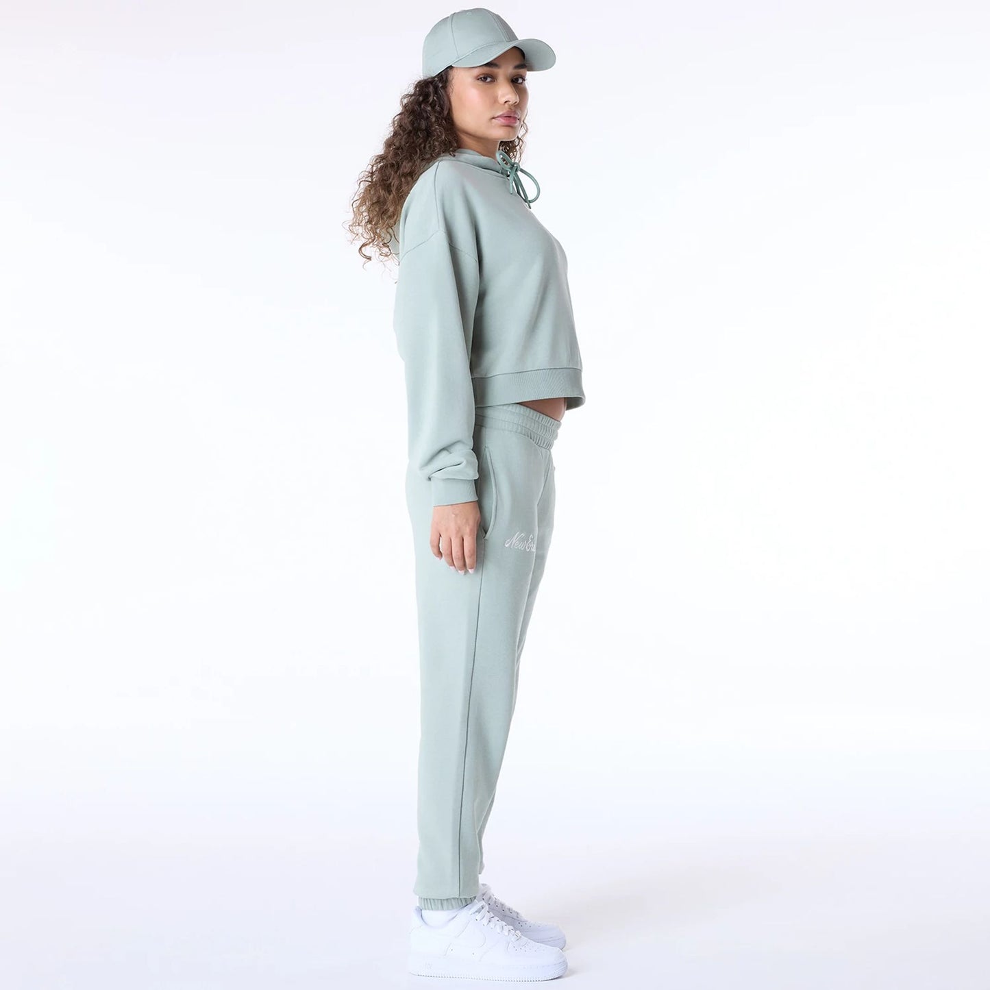 The Female model is wearing New Era Script Pastel Green Track Suit 2