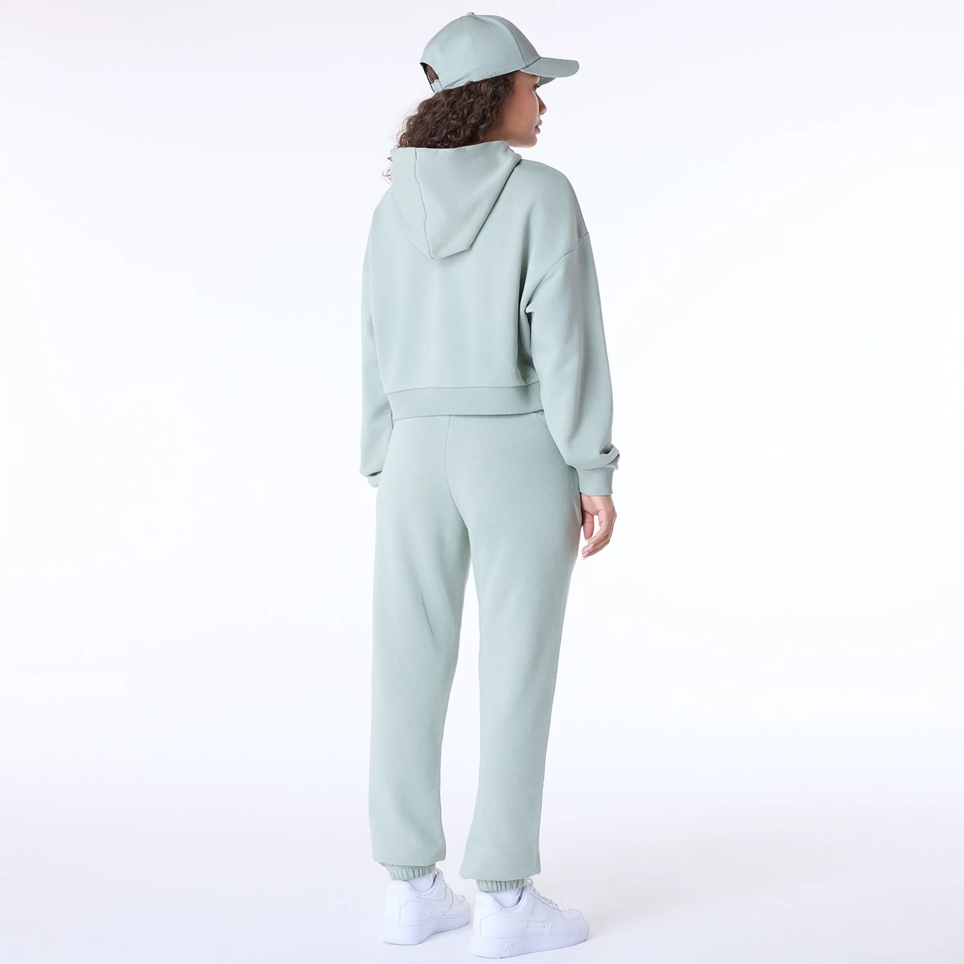 The Female model is wearing New Era Script Pastel Green Track Suit 5