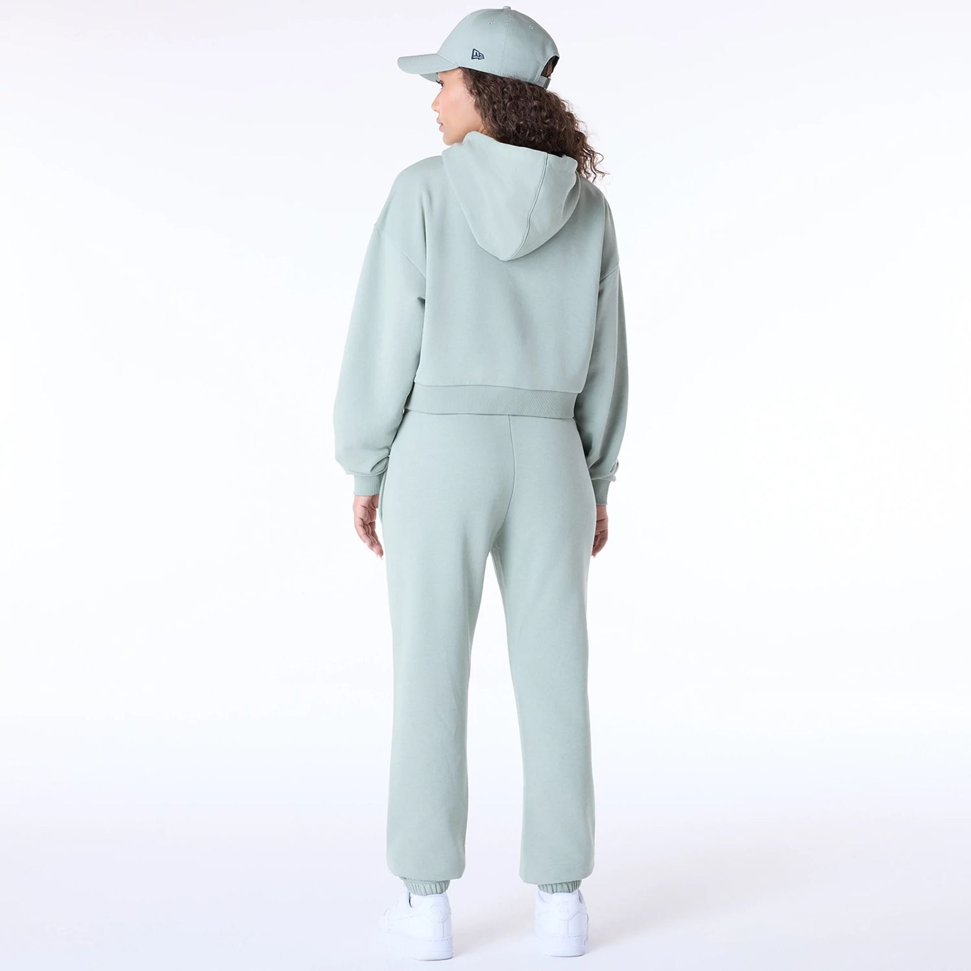 The Female model is wearing New Era Script Pastel Green Track Suit 3