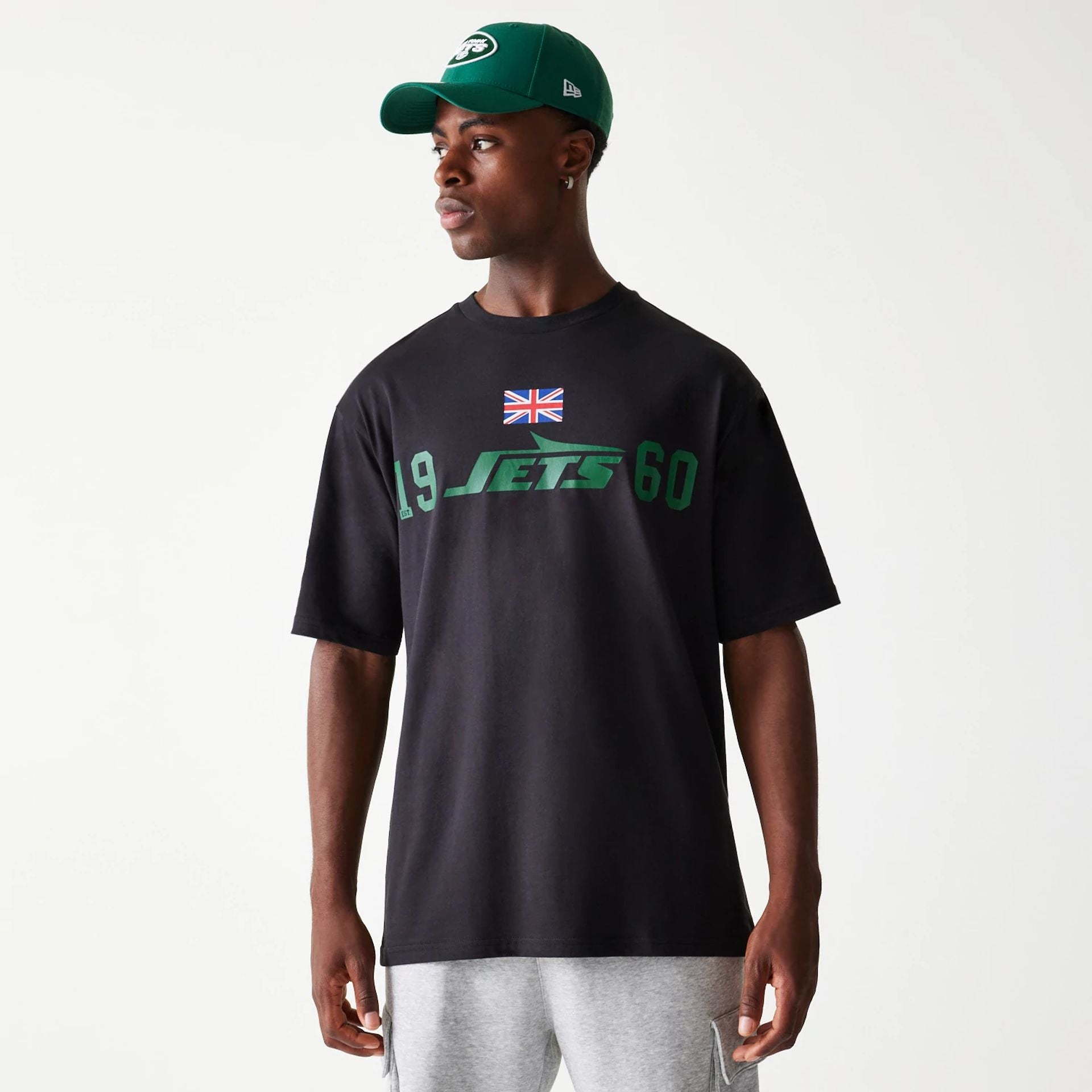 The Male model is wearing New York Jets NFL Games Square Arch Black Oversized T-Shirt 1