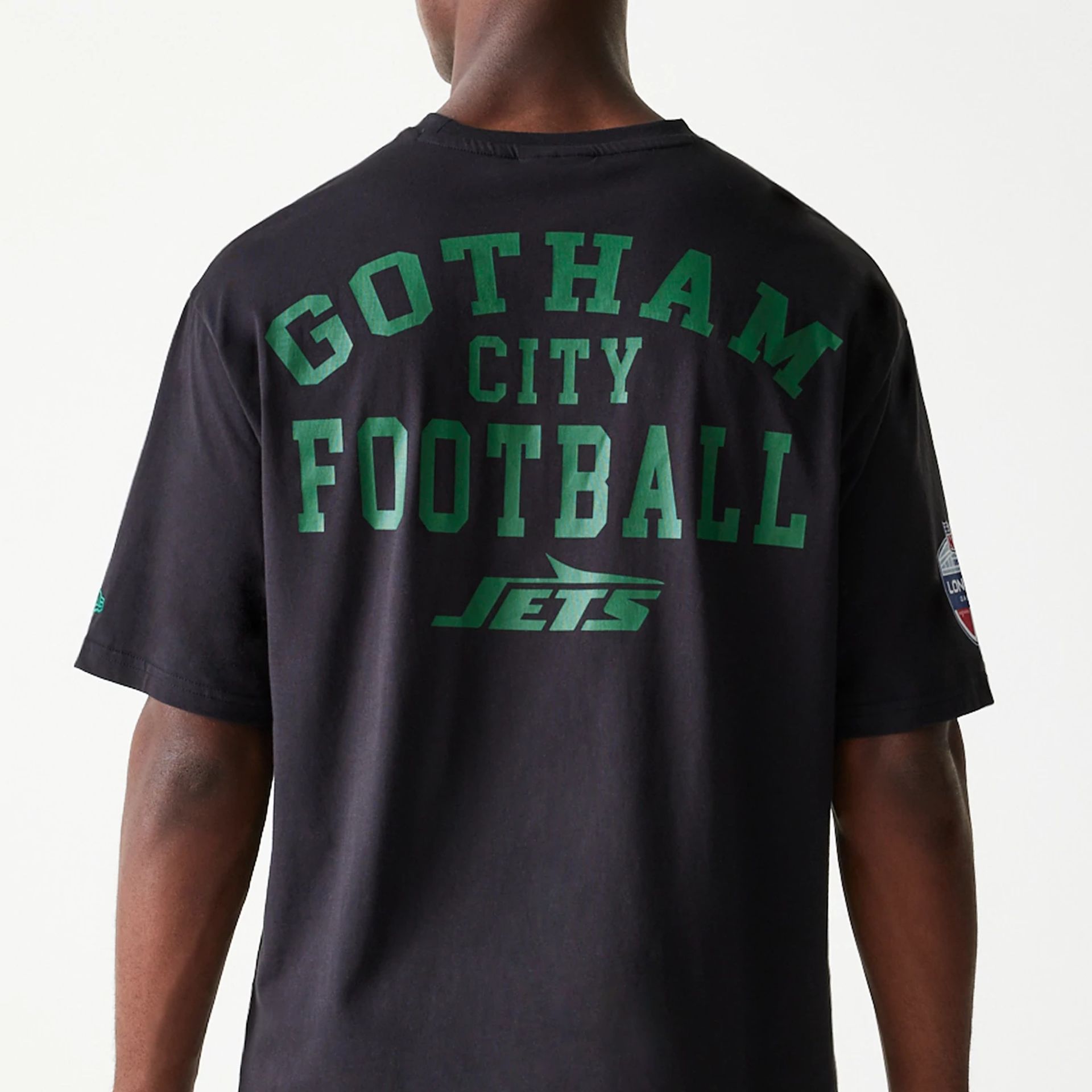 The Male model is wearing New York Jets NFL Games Square Arch Black Oversized T-Shirt 6