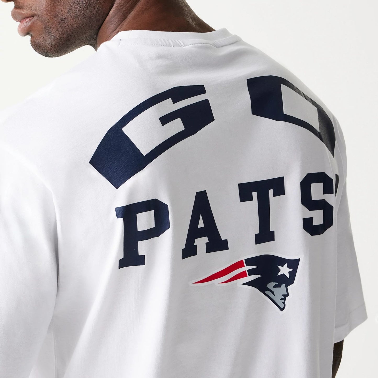 The Male model is wearing New England Patriots NFL Games Square Arch White Oversized T-Shirt 5