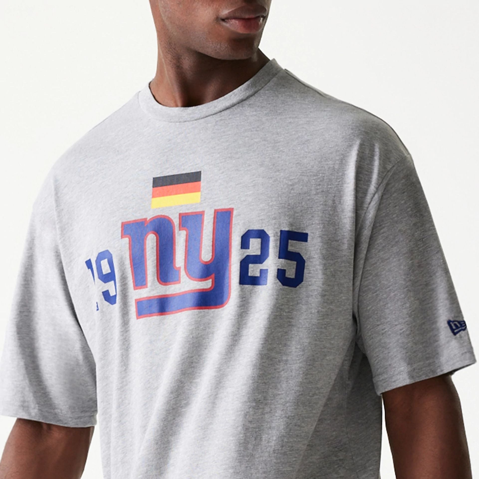 The Male model is wearing New York Giants NFL Games Square Arch Grey Oversized T-Shirt 2