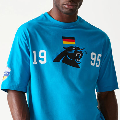 The Male model is wearing Carolina Panthers NFL Games Square Arch Bright Blue Oversized T-Shirt 2