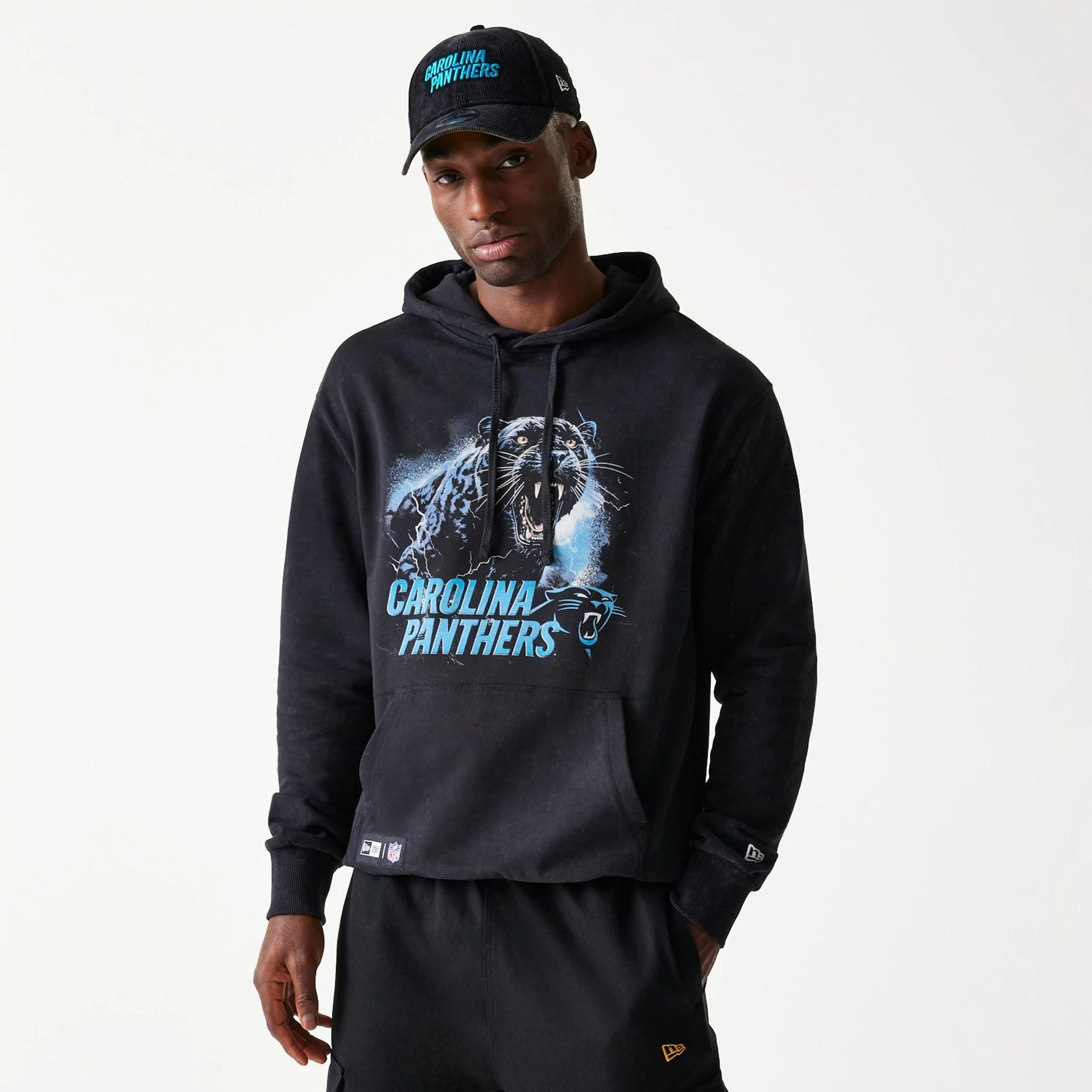 The Male model is wearing Carolina Panthers NFL Games Premium Apparel Black Oversized Pullover Hoodie 1