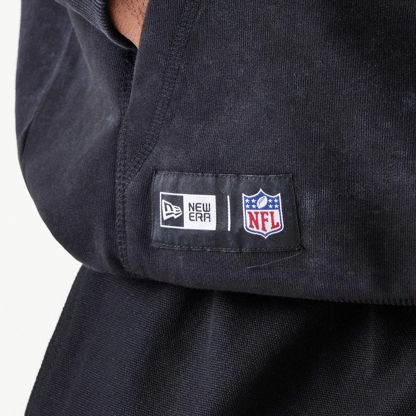 The Male model is wearing New England Patriots NFL Games Premium Apparel Black Oversized Pullover Hoodie 3