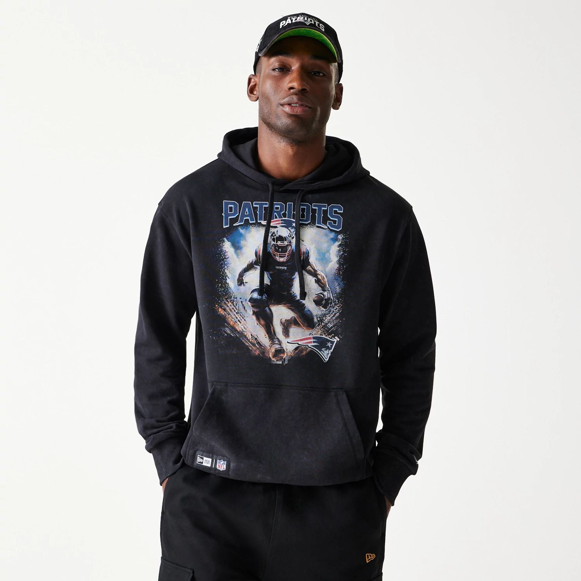 The Male model is wearing New England Patriots NFL Games Premium Apparel Black Oversized Pullover Hoodie 1