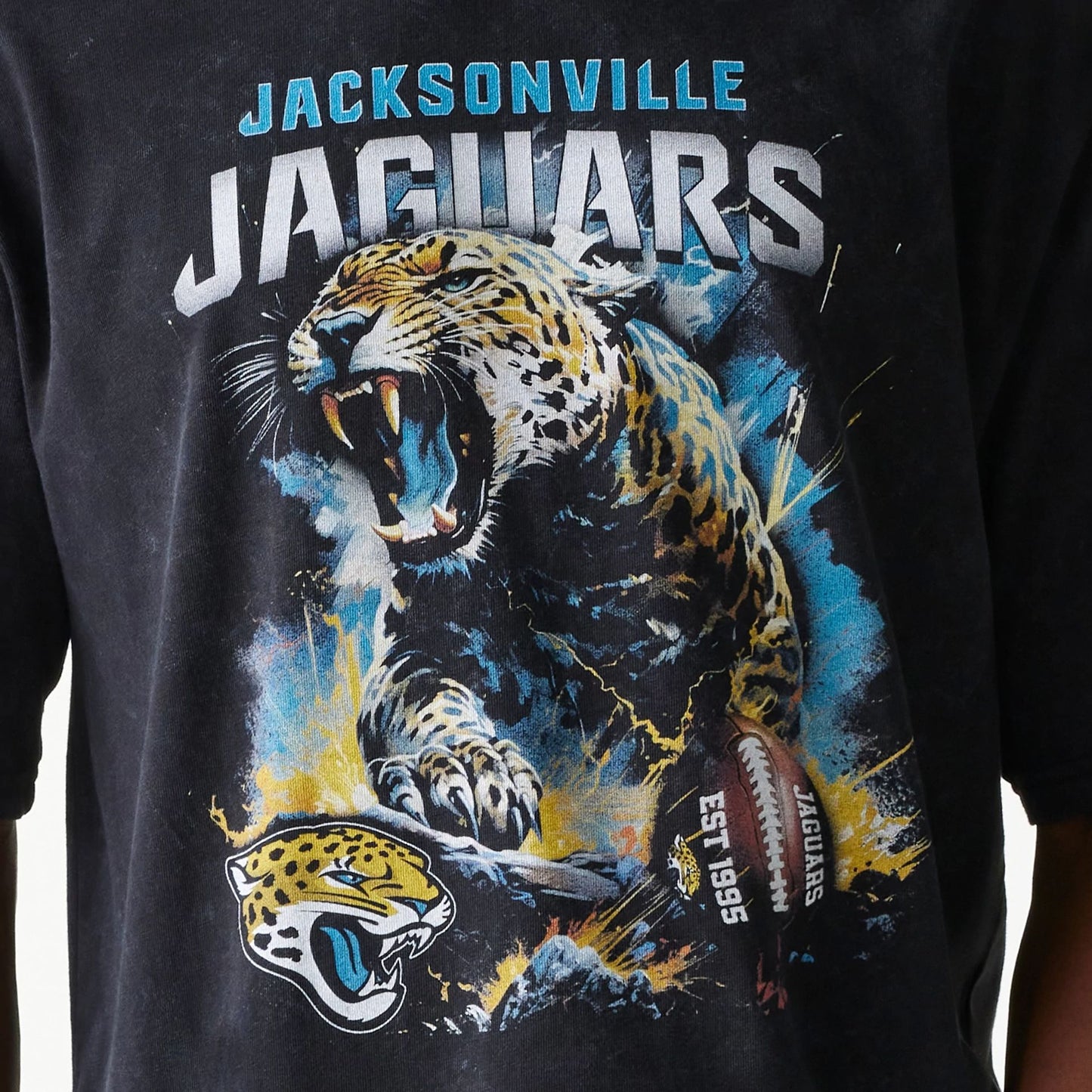 The Male model is wearing Jacksonville Jaguars NFL Games Premium Apparel Black Oversized T-Shirt 5