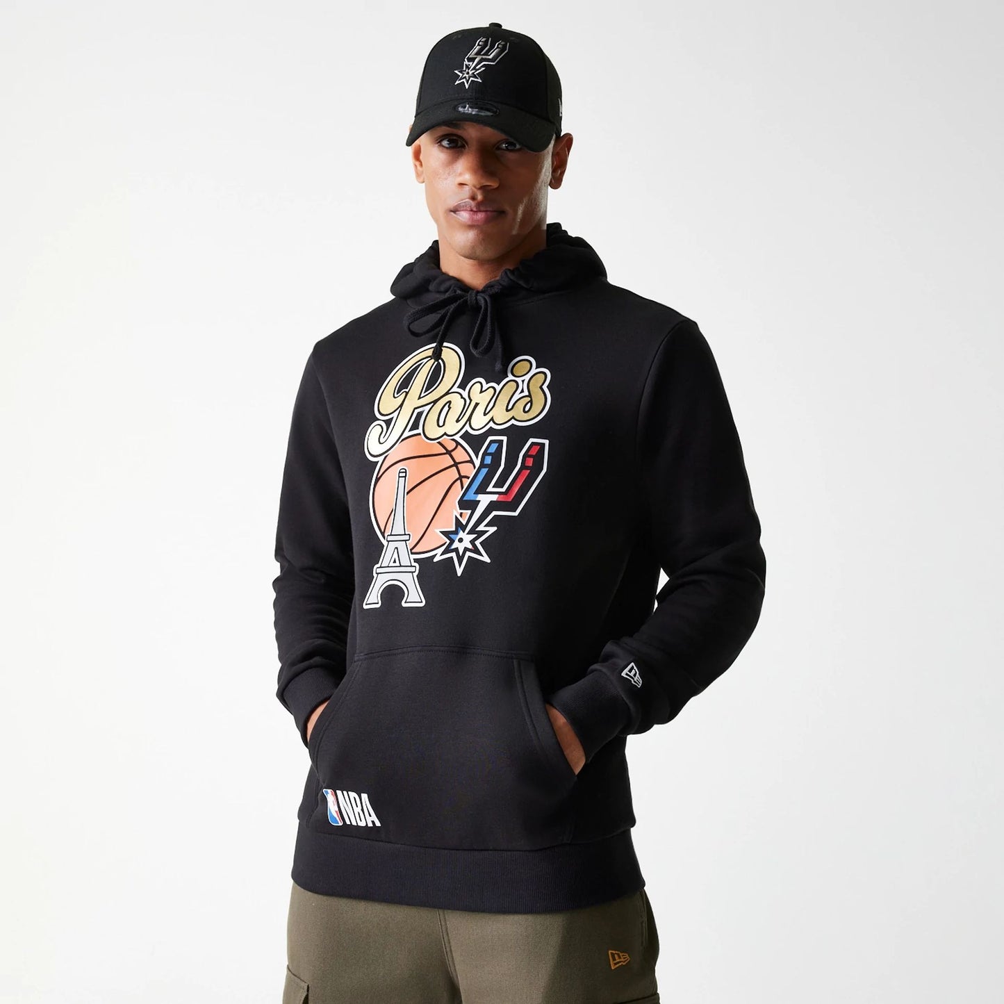 The Male model is wearing San Antonio Spurs NBA Paris Games 2025 Black Pullover Hoodie 1