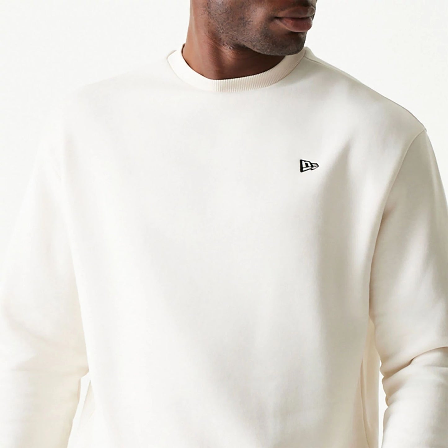 The Male model is wearing New Era Essential Brushed Fleece White Crewneck Sweater 3