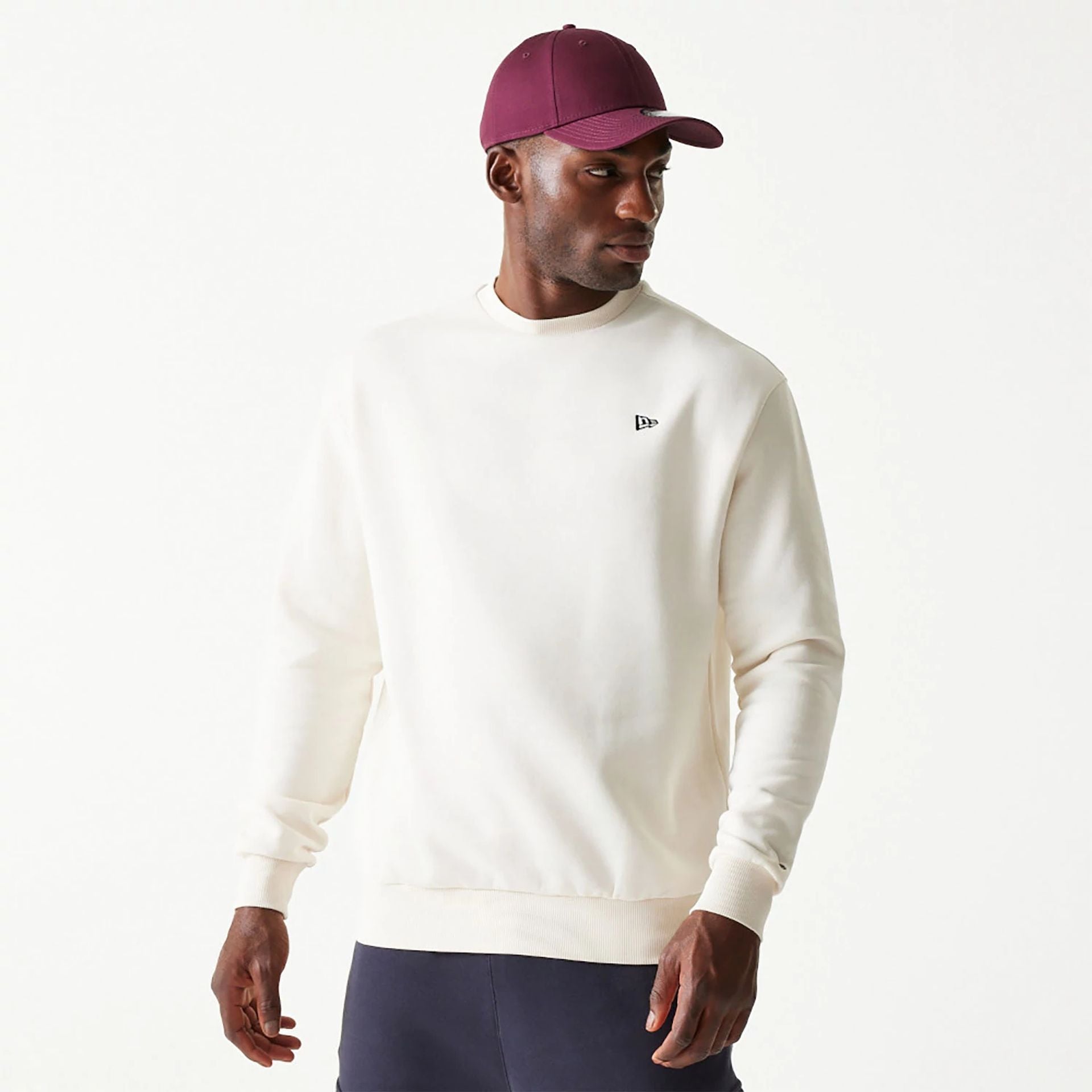 The Male model is wearing New Era Essential Brushed Fleece White Crewneck Sweater 1