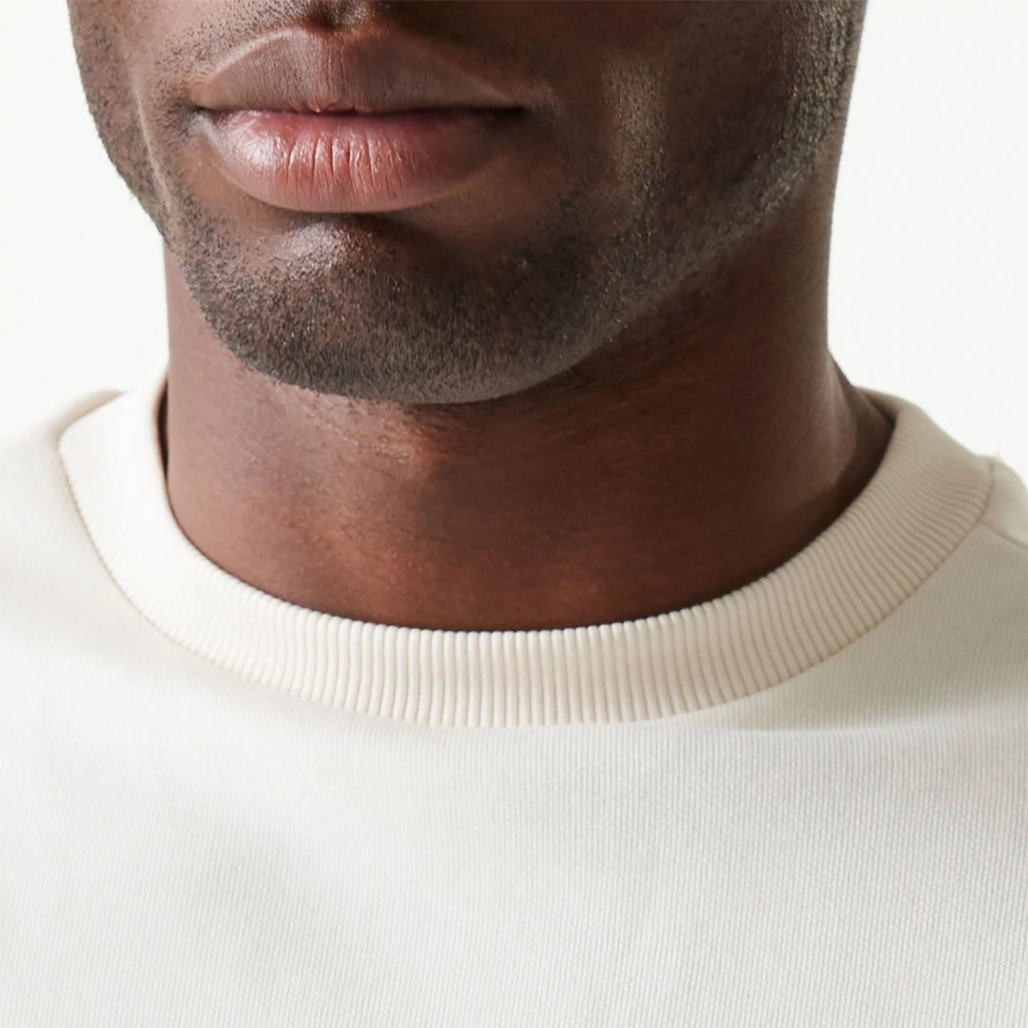 The Male model is wearing New Era Essential Brushed Fleece White Crewneck Sweater 6