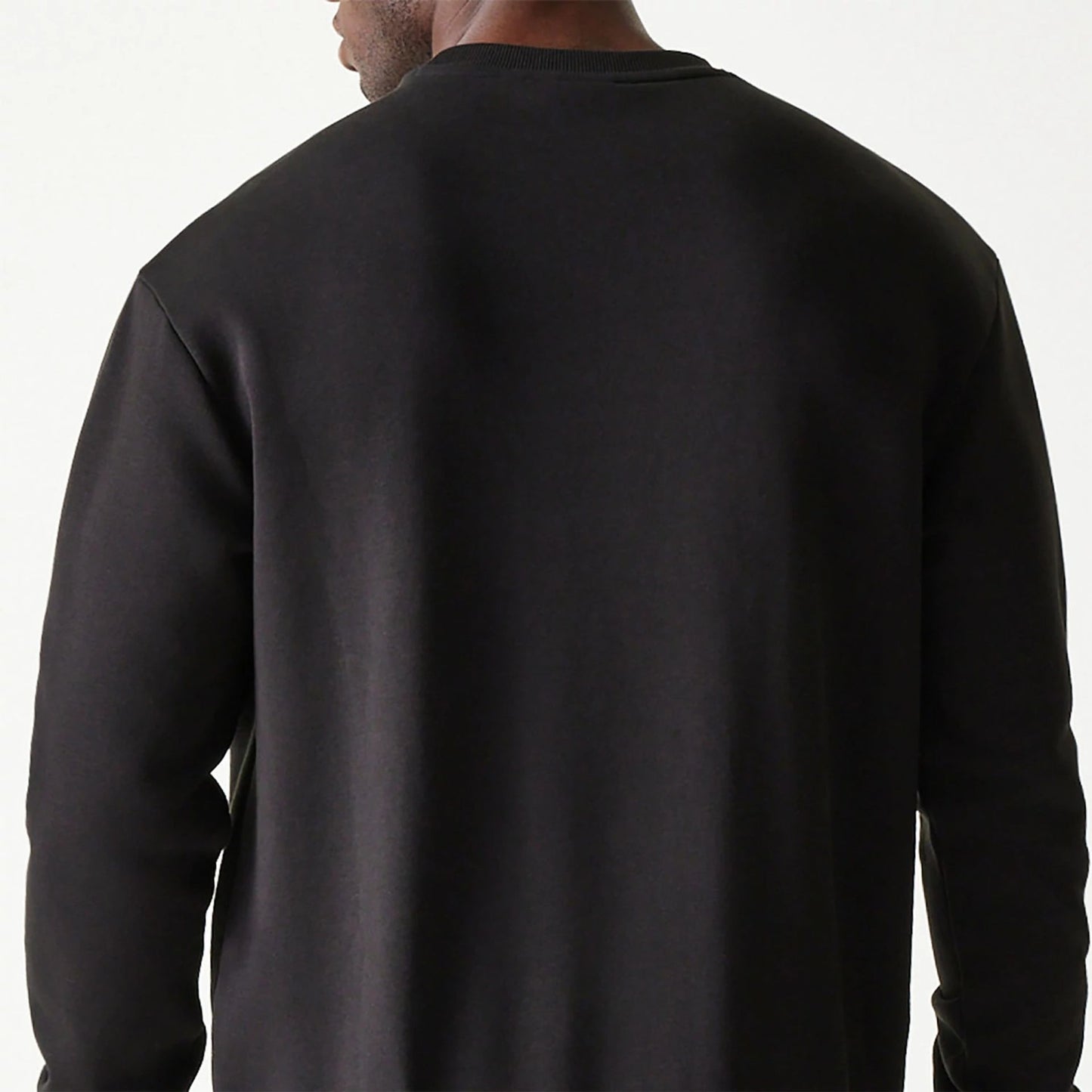 The Male model is wearing New Era Essential Brushed Fleece Black Crewneck Sweater 7