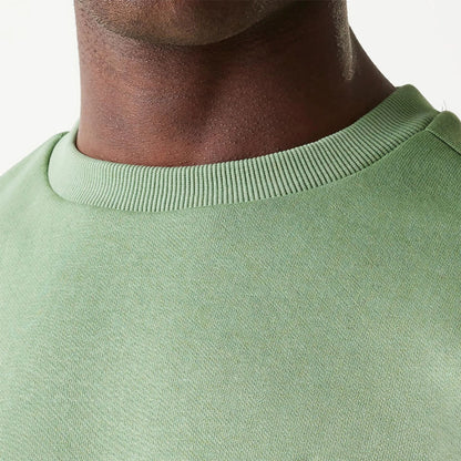 The Male model is wearing New Era Essential Brushed Fleece Green Crewneck Sweater 6