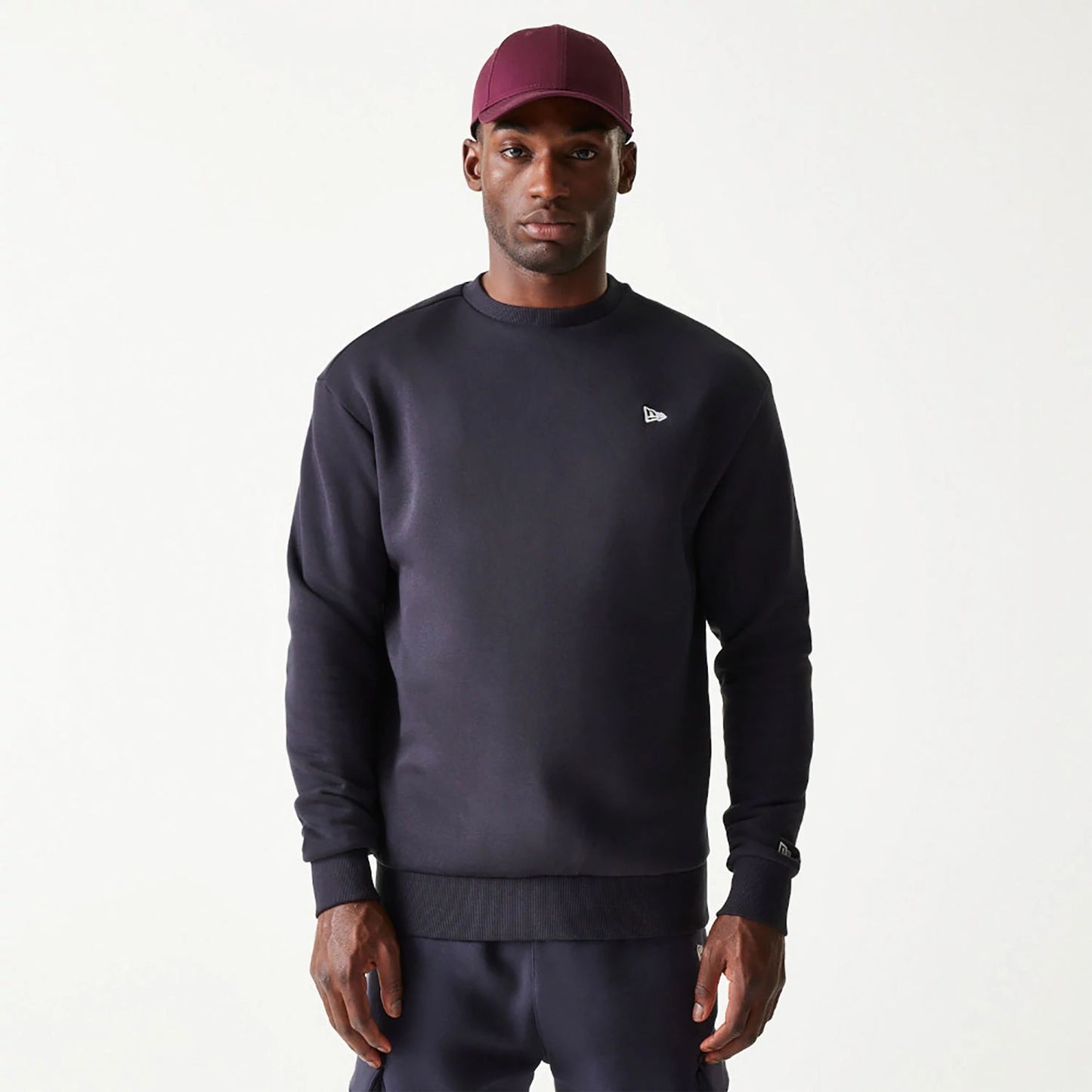 The Male model is wearing New Era Essential Brushed Fleece Navy Crewneck Sweater 1