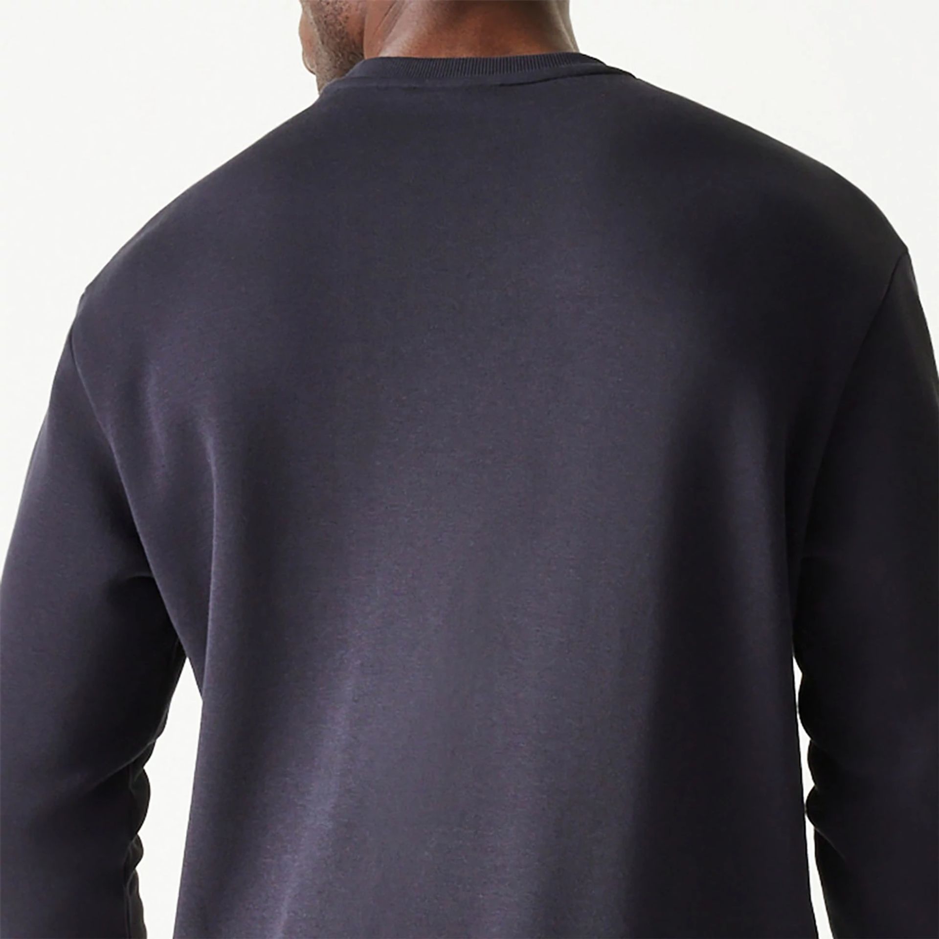 The Male model is wearing New Era Essential Brushed Fleece Navy Crewneck Sweater 6