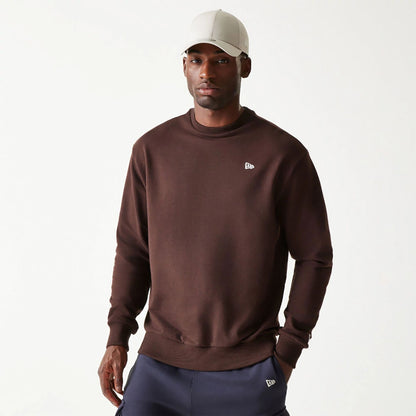 The Male model is wearing New Era Essential Dark Brown Crewneck Sweater 1