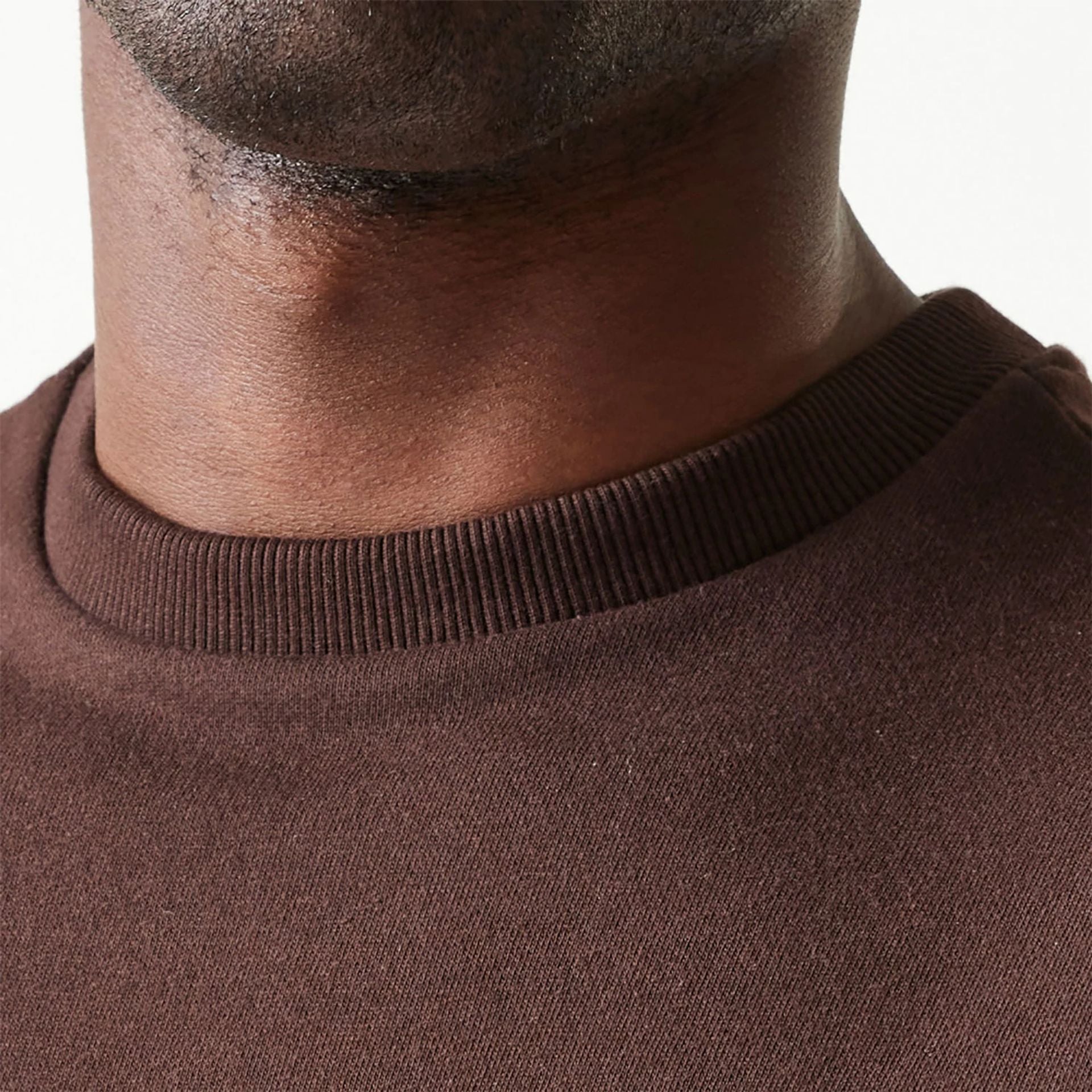 The Male model is wearing New Era Essential Dark Brown Crewneck Sweater 6