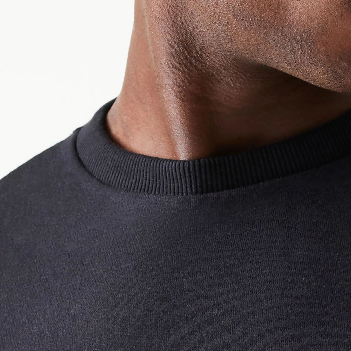 The Male model is wearing New Era Essential Black Crewneck Sweater 6