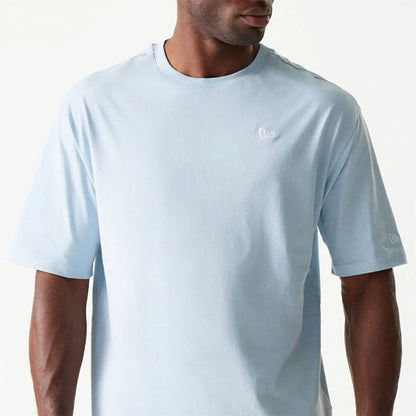 The Male model is wearing New Era Essential Pastel Blue Oversized T-Shirt 3