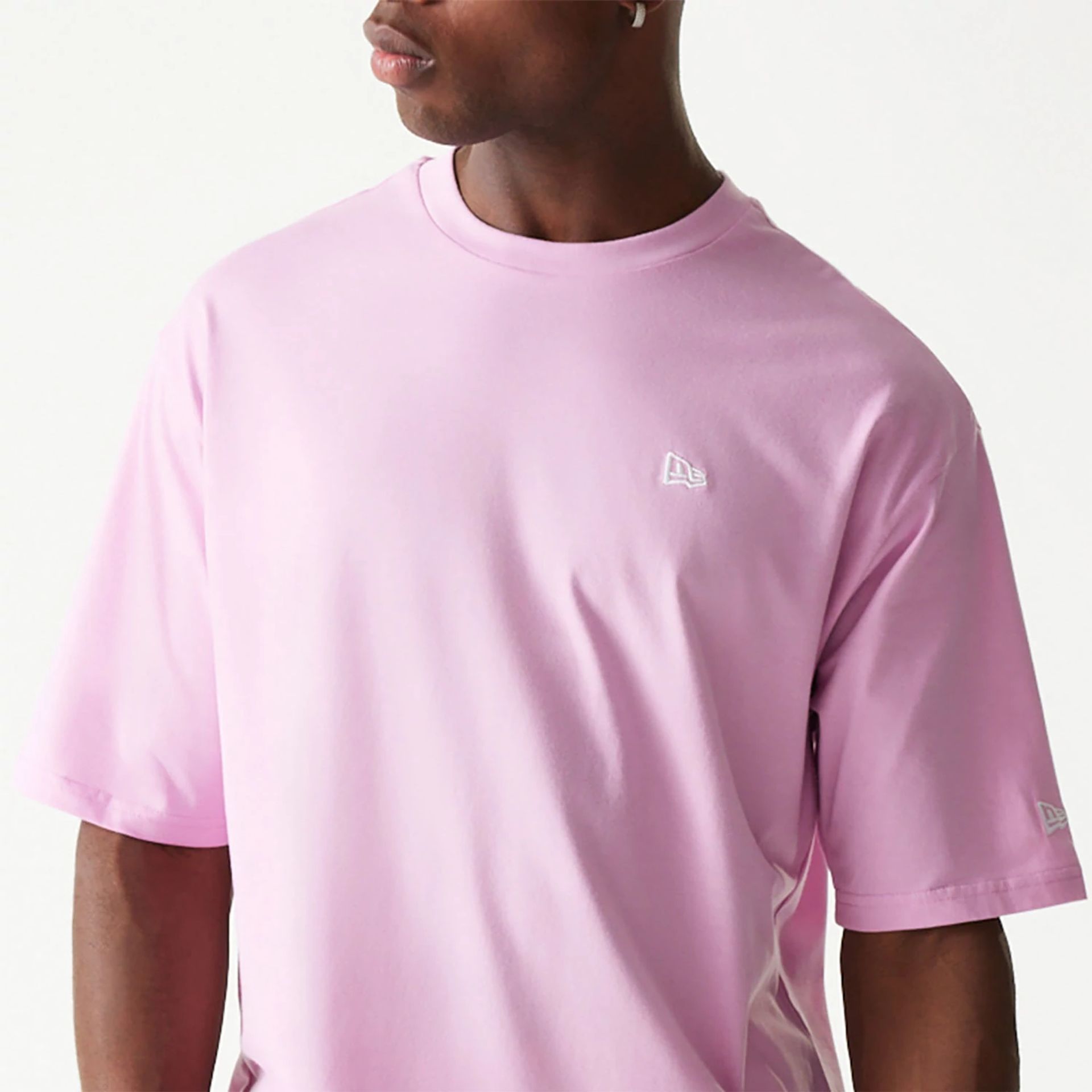 The Male model is wearing New Era Essential Pastel Pink Oversized T-Shirt 3