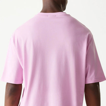 The Male model is wearing New Era Essential Pastel Pink Oversized T-Shirt 7