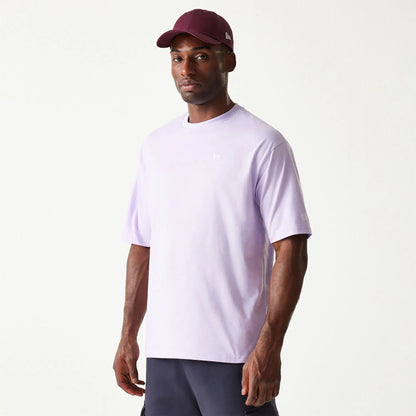 The Male model is wearing New Era Essential Pastel Purple Oversized T-Shirt 1