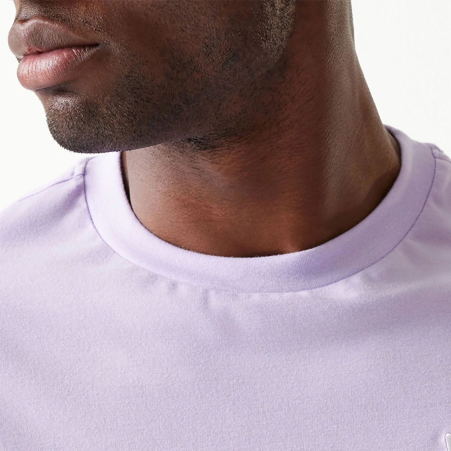 The Male model is wearing New Era Essential Pastel Purple Oversized T-Shirt 4