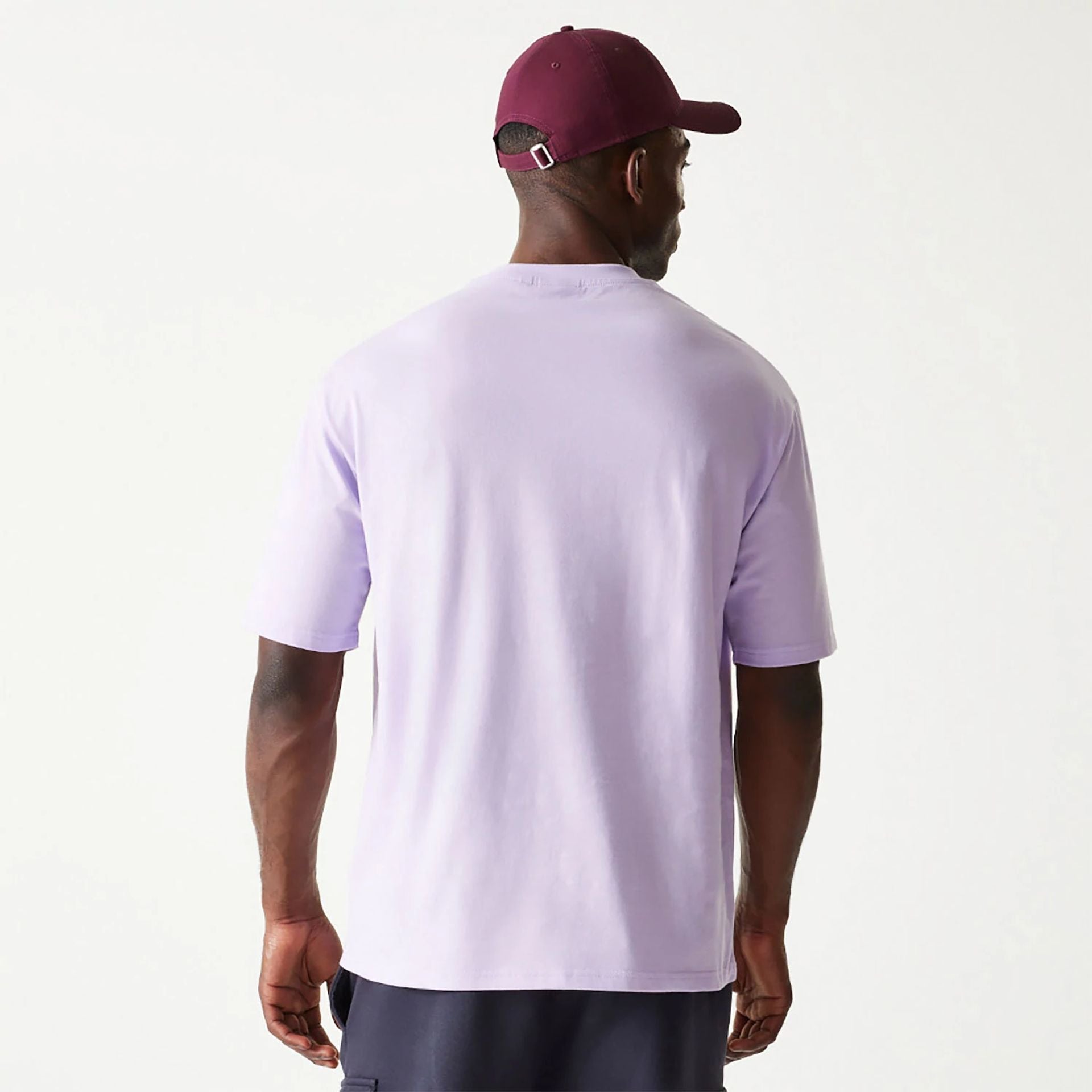 The Male model is wearing New Era Essential Pastel Purple Oversized T-Shirt 2